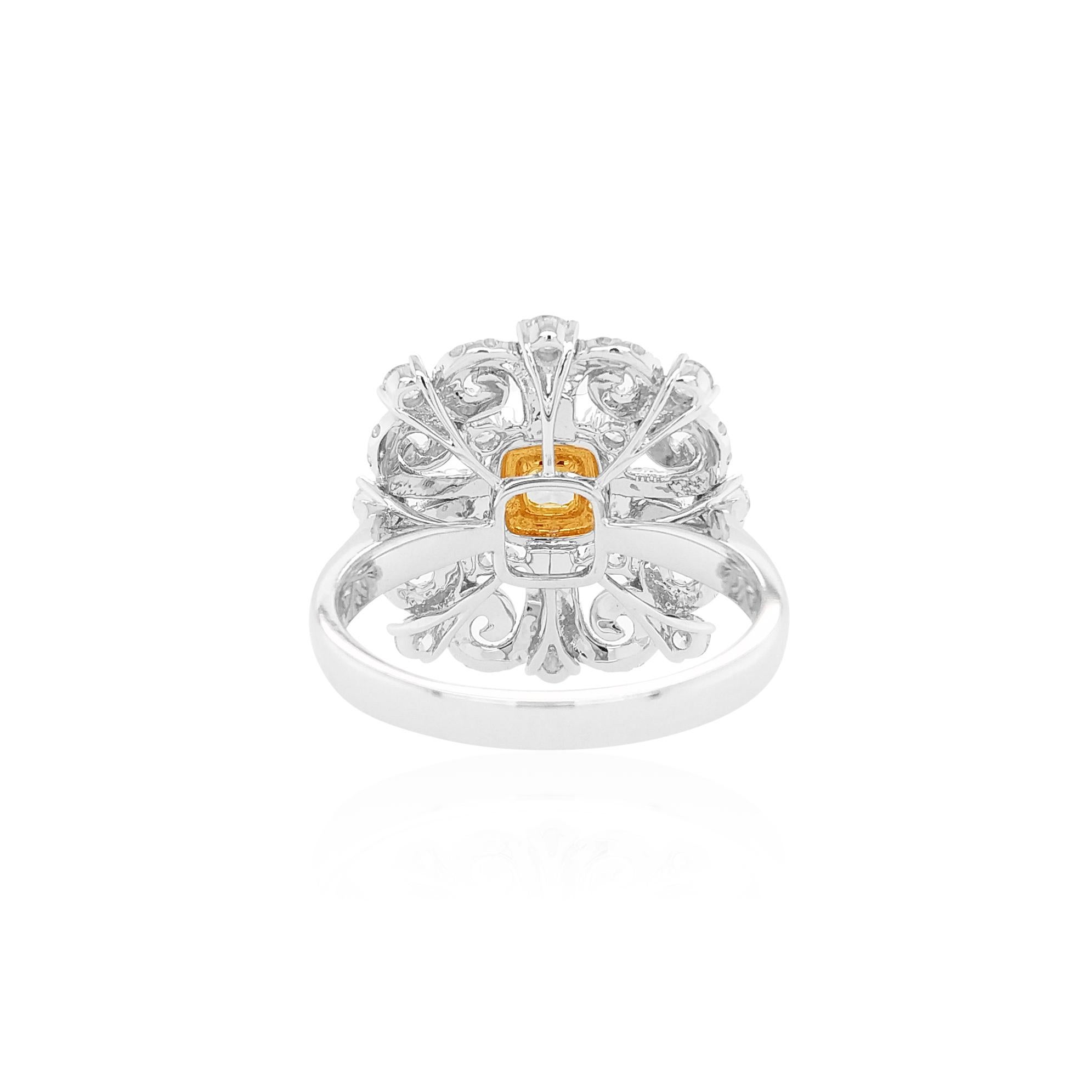 This stunning 18 Karat White Gold ring features a rich hue Fancy Intense Yellow Diamond at its centre, surrounded by a halo of Yellow Diamonds and a bold pattern of scintillating White Diamonds which enables the light to sparkle in a unique way. Set