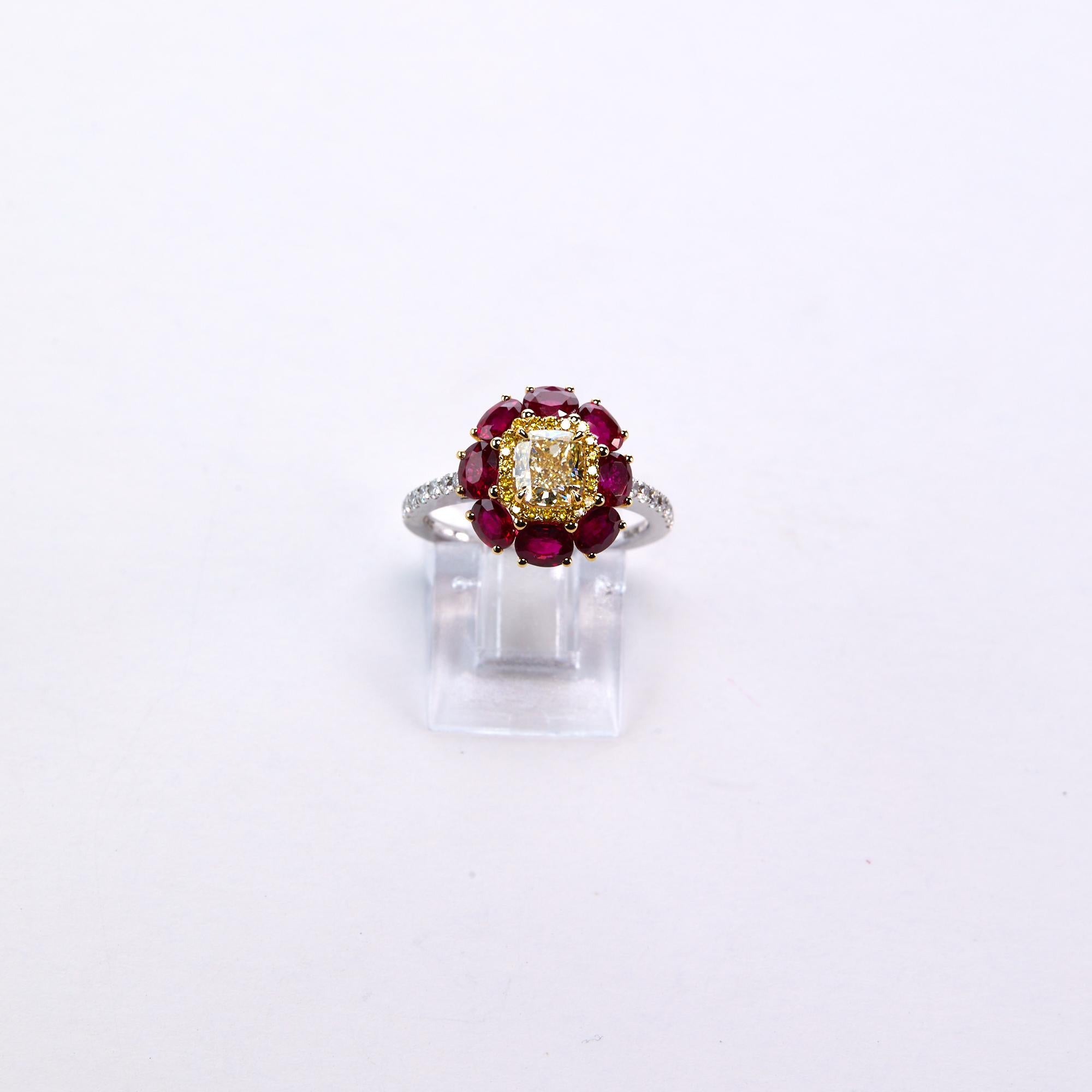 Certified Fancy Yellow And Ruby Engagement Ring. This beautiful Italian design combines 2.26 carats of oval shaped rubies with a vibrant .91 certified Fancy Yellow Cushion Cut as the center stone and .23 carats of round brilliant diamonds for the