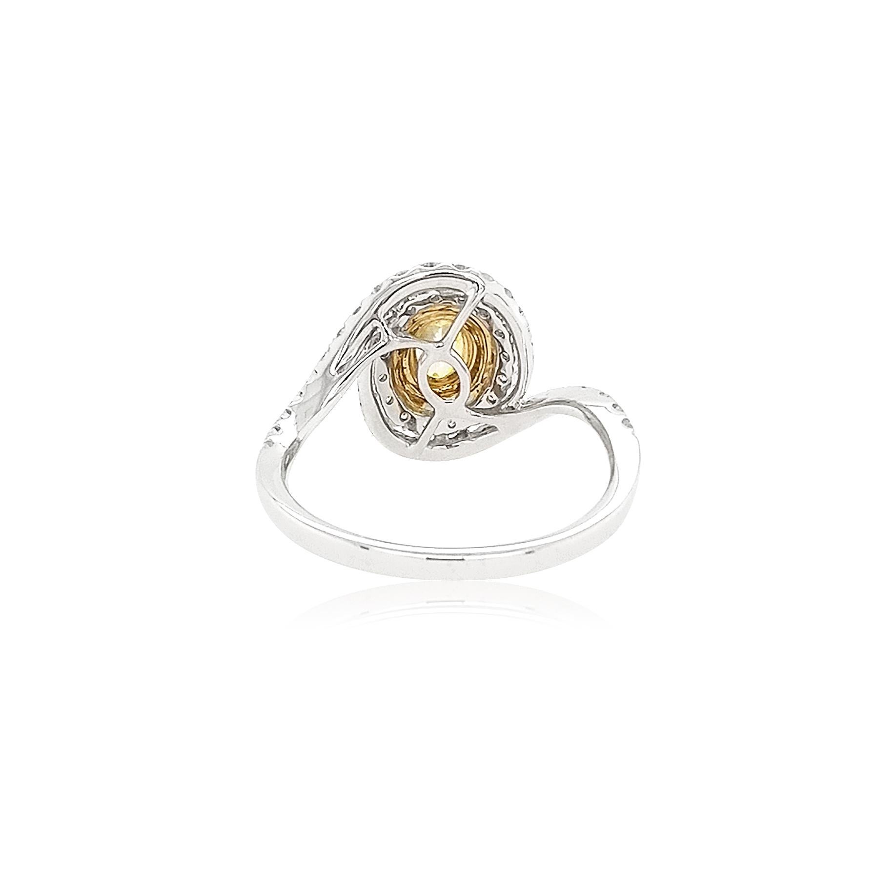 This delicate platinum ring features the lustrous natural Fancy Yellow Diamond at the forefront of its design. The spectacular hues of the Yellow Diamonds are perfectly accentuated by the platinum and 18 Karat yellow gold setting, and elegant