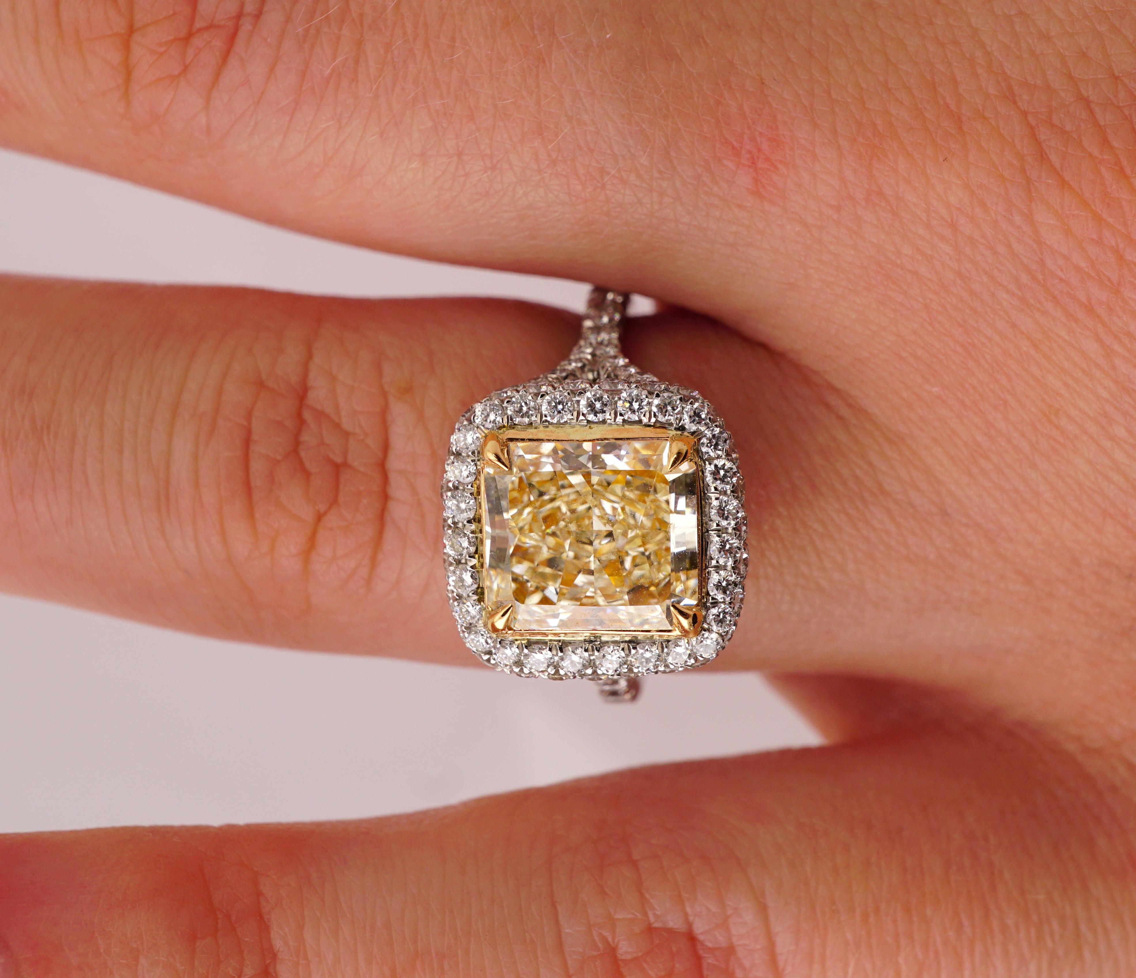 Fancy Yellow Diamond Platinum ring with EGL certificate: no.US 400119130D. Center stone: 2.84ct Radiant cut Fancy Light Yellow VS1 diamond. Center stone measurements: 8.90 x 7.80 mm. Side stones: 1.16ct F-G VS1-VS2 Brilliant Round diamonds. Total