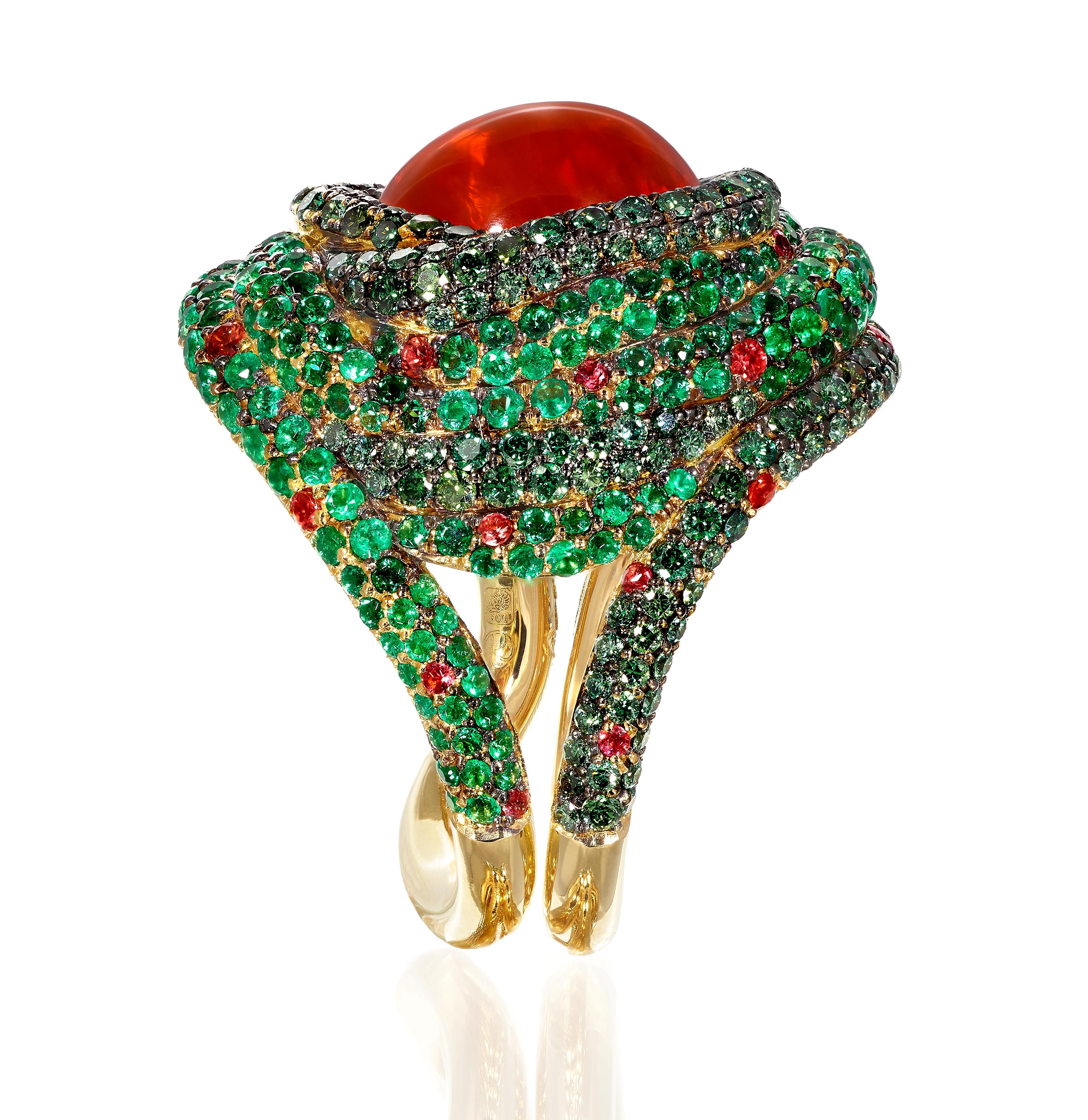 Rosior Contemporary Cocktail Ring set in Yellow Gold with:
- 1 Cabochon Cut Fire Opal with 4,93 ct, certified by AIGS (ref. GF21051067);
- 226 Emeralds with 1,59 ct;
- 205 Green Diamonds with 1,22 ct;
- 12 Orange Sapphires with 0,21 ct.
This unique