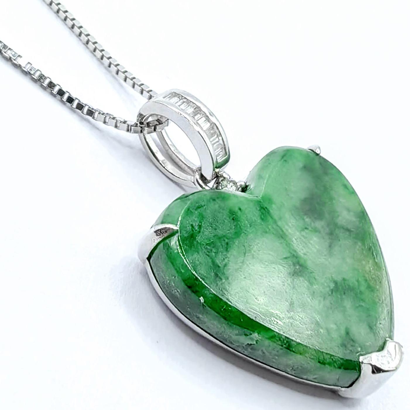 Discover the romantic elegance of this Flower-Green Jadeite Jade Heart Pendant, crafted from genuine Flower-Green (花青) jadeite, prized for its marbled emerald green tones flowing through translucent lighter areas like delicate brushstrokes on