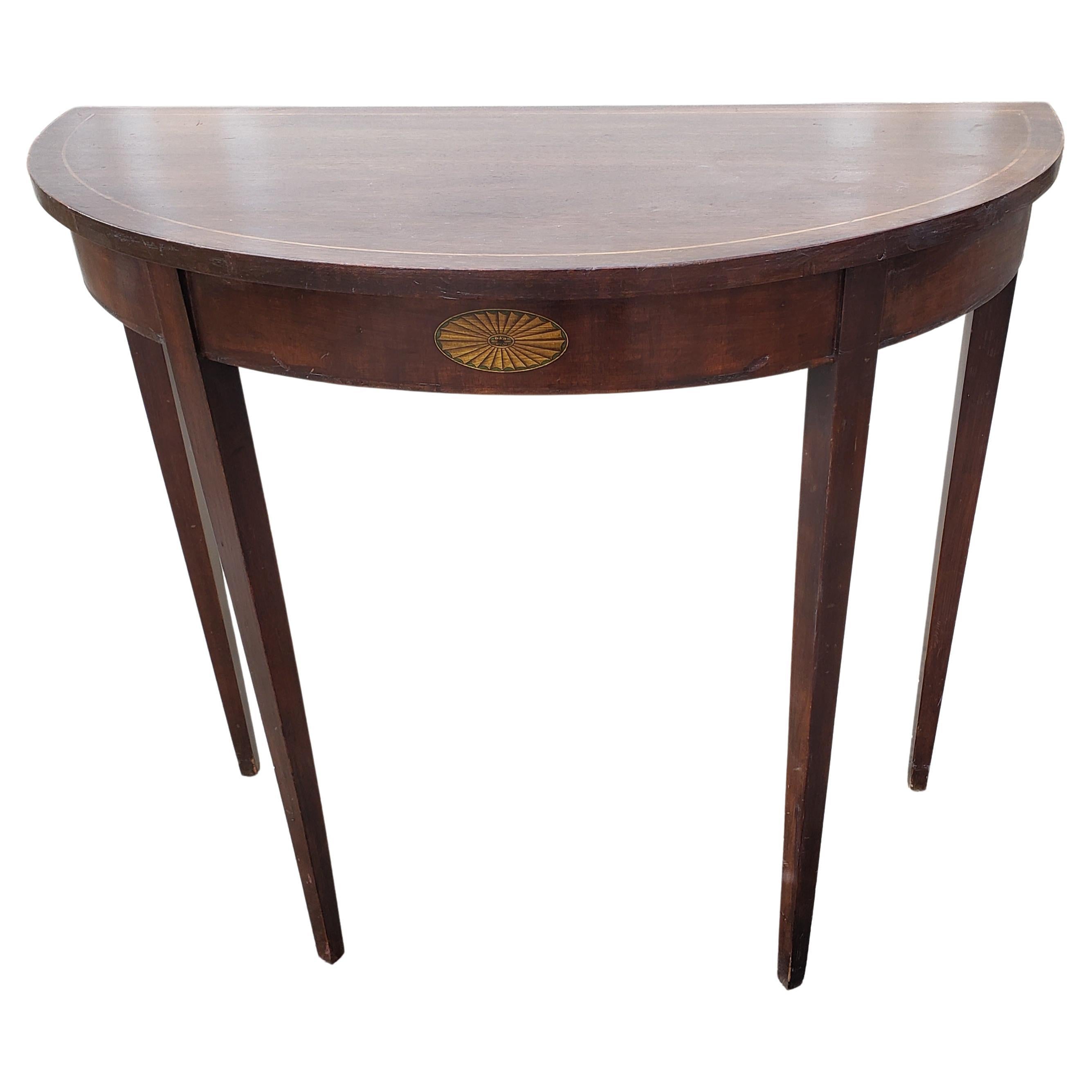 Solid Certified Genuine Mahogany inlaid Demi Lune table built in 1940s and certified by the famous Mahogany Association of the United States. Good vintage condition with some nicks consistent with age and use. 
Measures 34 inches in width, 16
