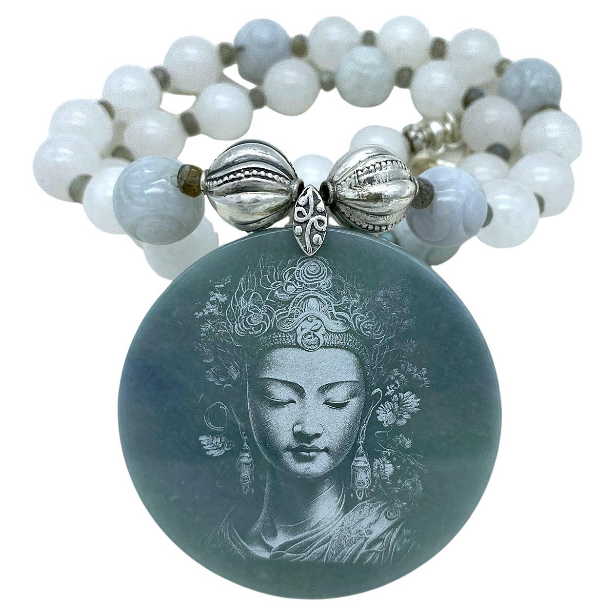 This is a grade A jadeite necklace with a Guanyin pendant. We created this long strand necklace with 12mm smooth white jade beads with six 14mm carved lite green jade beads and a shadow carving Guanyin Bodhisattva pendant (A certificate of