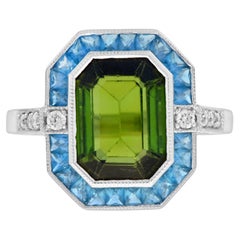 Anello aureolato con tormalina verde certificata e diamante Topazio blu di Londra in oro bianco 14 carati