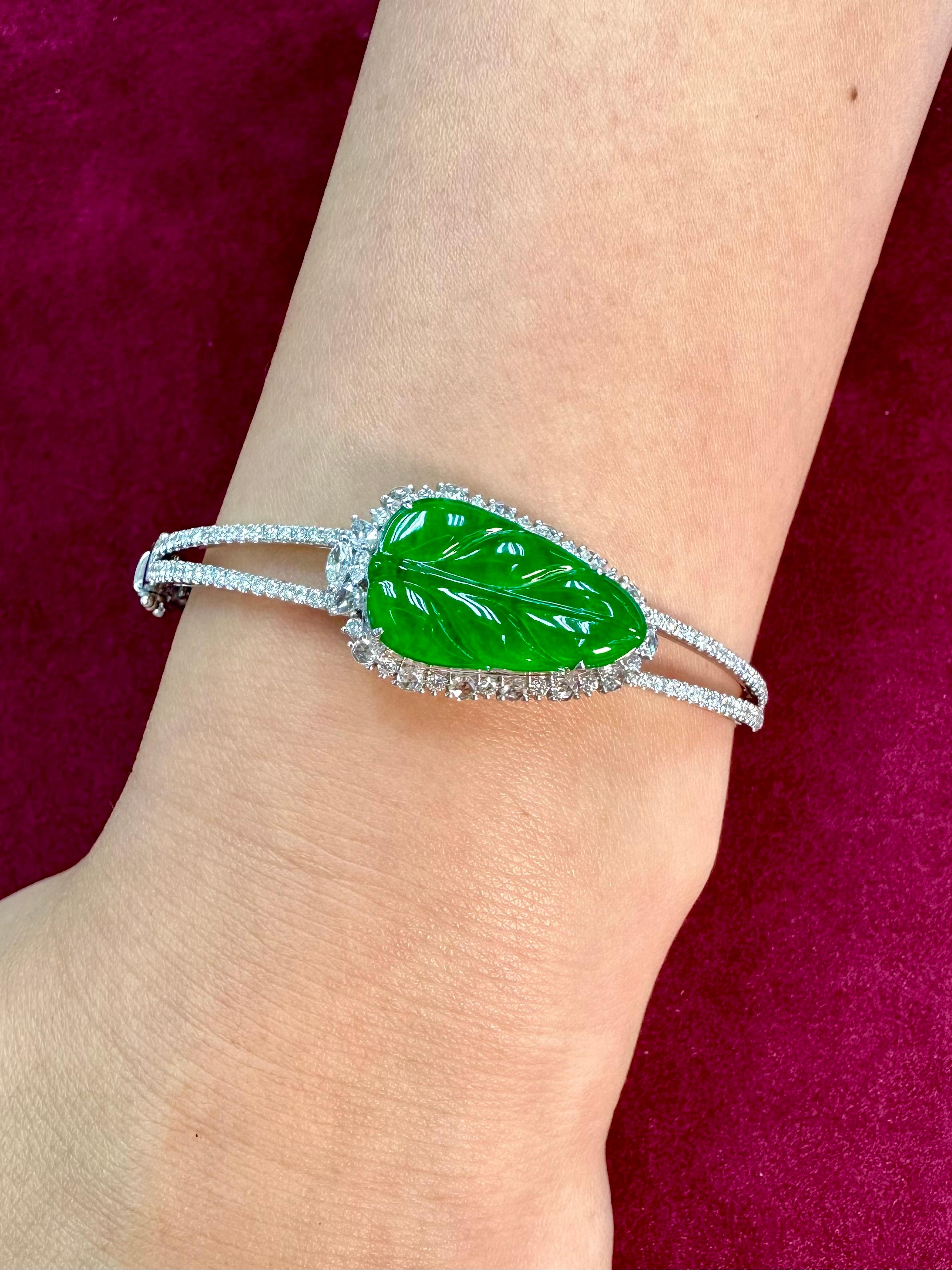 Please check out the HD video! This is certified by two labs to be natural jadeite jade. The bangle bracelet is set in 18k white gold. There is one large carved apple green jade leaf surrounded by 1.35cts of new rose cut and round brilliant white