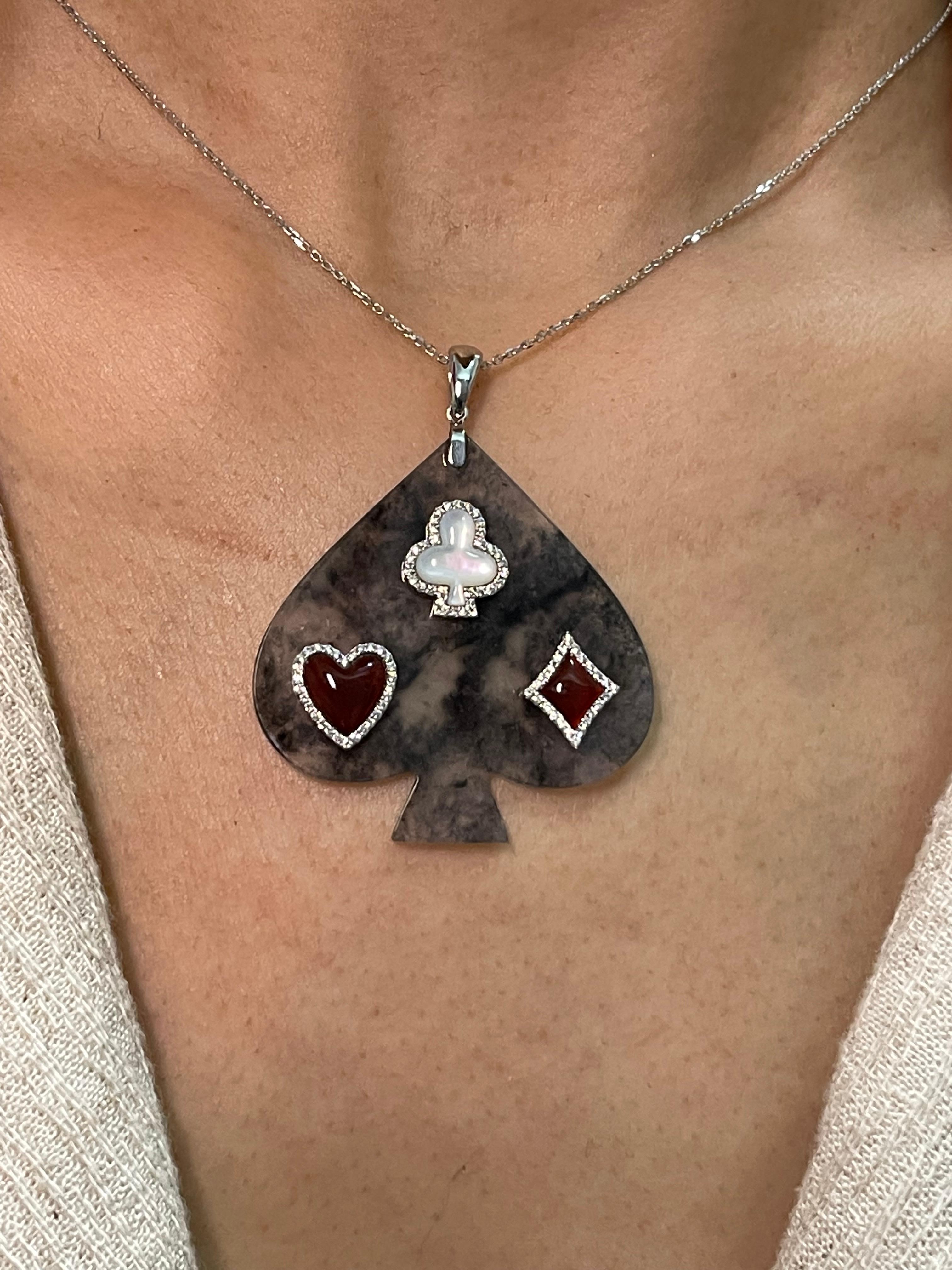 Please check out the HD video! Unique to only one piece! This is the perfect icy black jade. It is a specialty cut jade with custom cut mother of pearl, custom cut red agate and diamonds. Perfect for that poker player or card shark! Icy black jade
