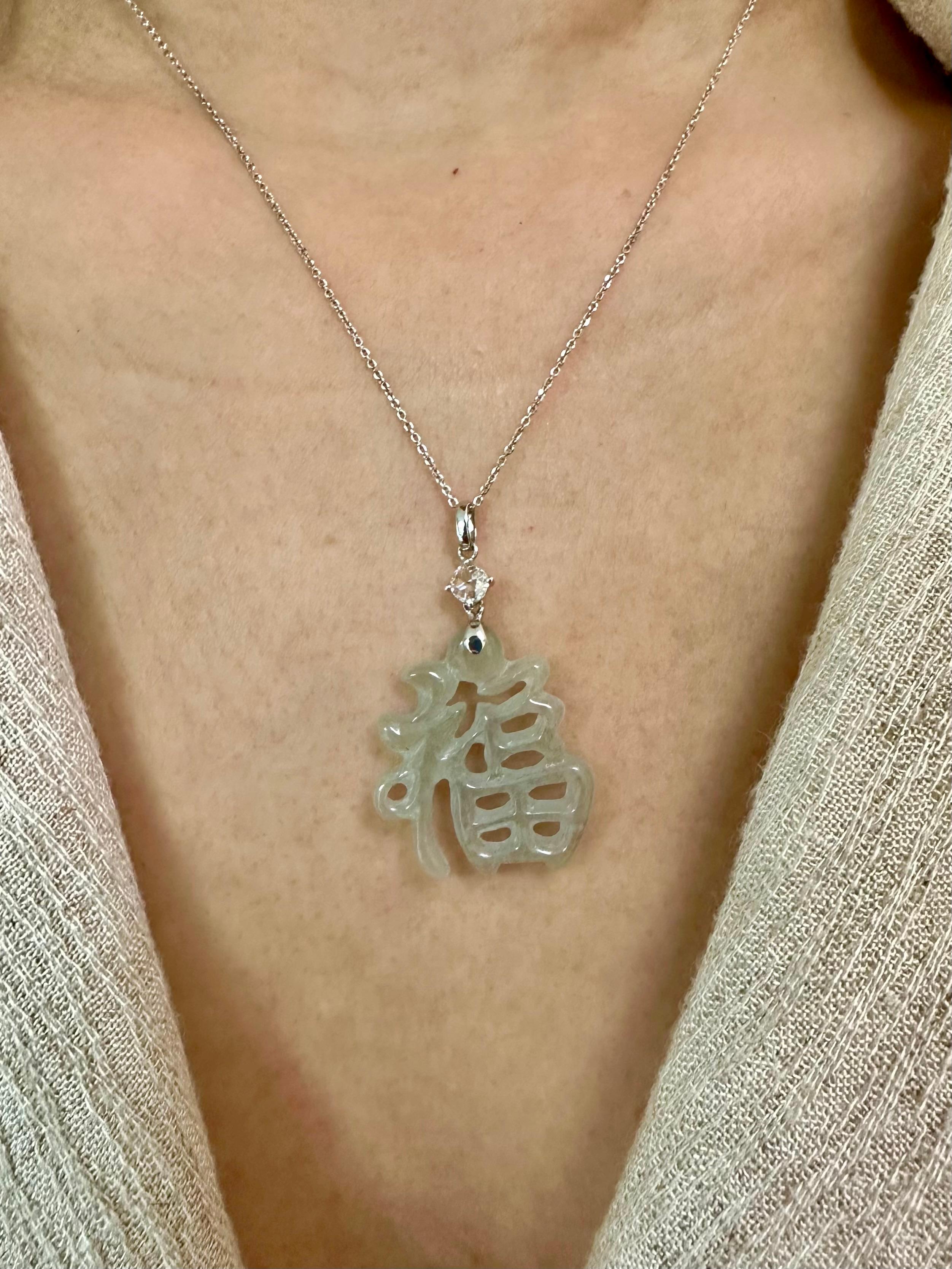 Please check out the HD video. Here is a natural Jadeite Jade and diamond pendant. It is certified natural without any treatments. The pendant is set in 18k white gold and one new rose cut diamond 0.145 cts. The carving is of the Chinese character