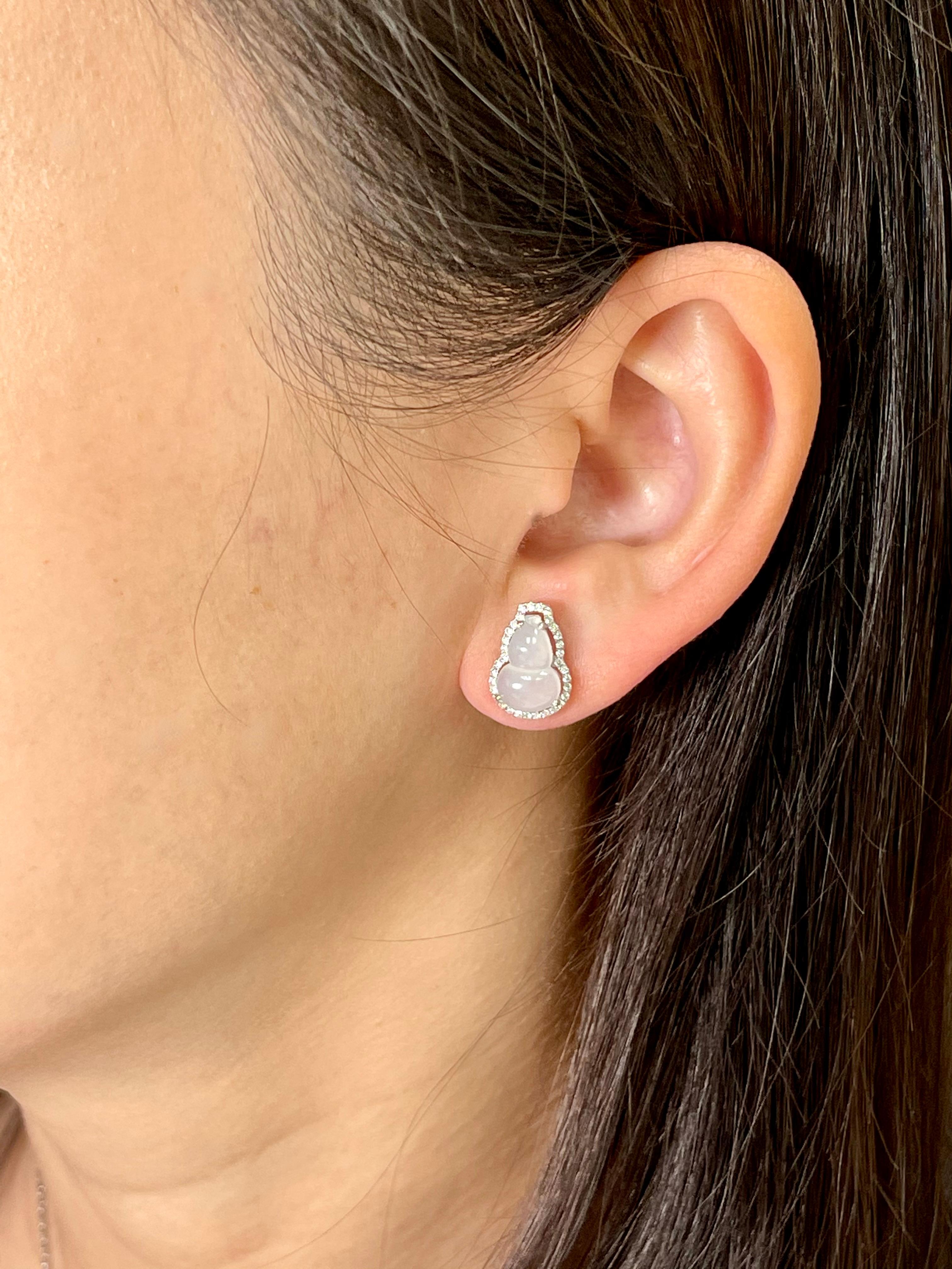 The perfect icy jade earrings! Here is a pair of natural Icy Jadeite Jade and diamond earrings. Icy jade of this quality extremely hard to come by and is in high demand. It is certified colorless. The jade gourds represent the Fulu double, it