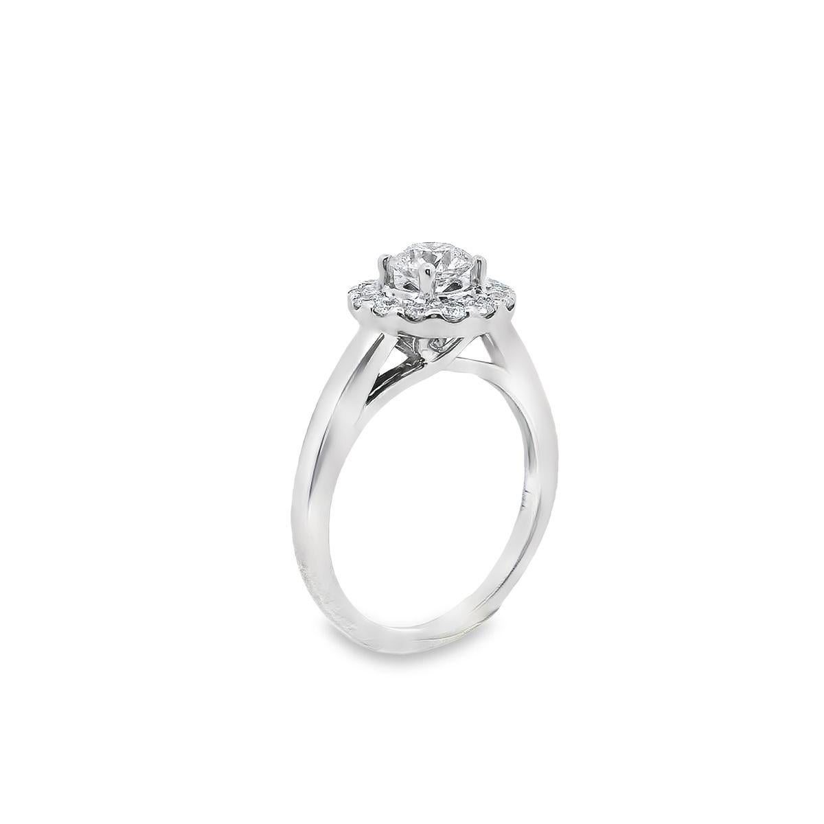 Simply romantic diamond engagement ring offered by Alex & Co. This 14 karat white gold and diamond ring features a dazzling prong set round  Ideal Cut center stone weighing .47ct., with a color grade of  near colorless (I) and S. The diamond is