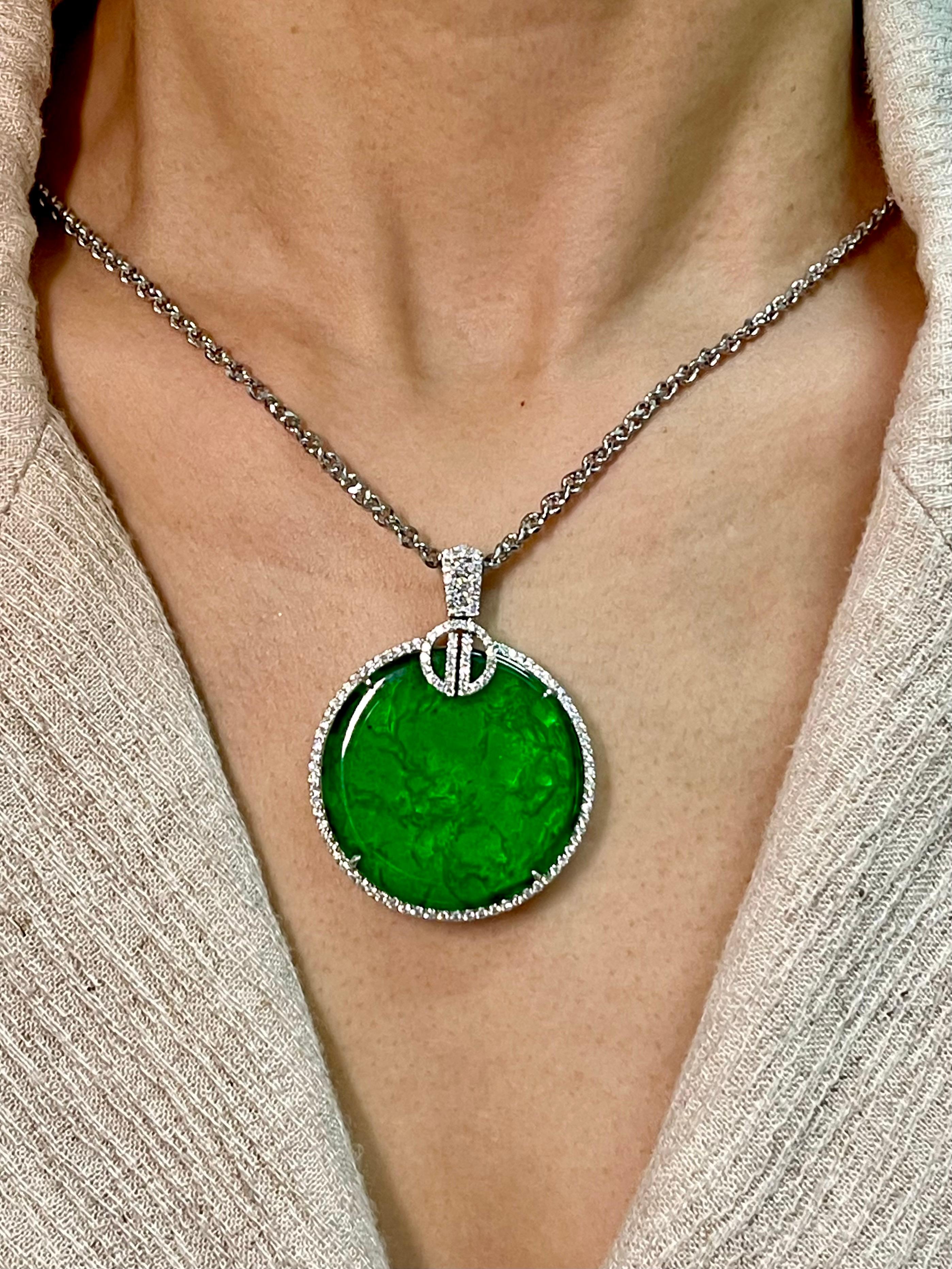 This is a collector's item! This certified natural jadeite jade is with no treatment and un-enhanced. The pendant is set in 18k white gold and diamonds. There are 1.08cts of white diamonds in this pendant. The 