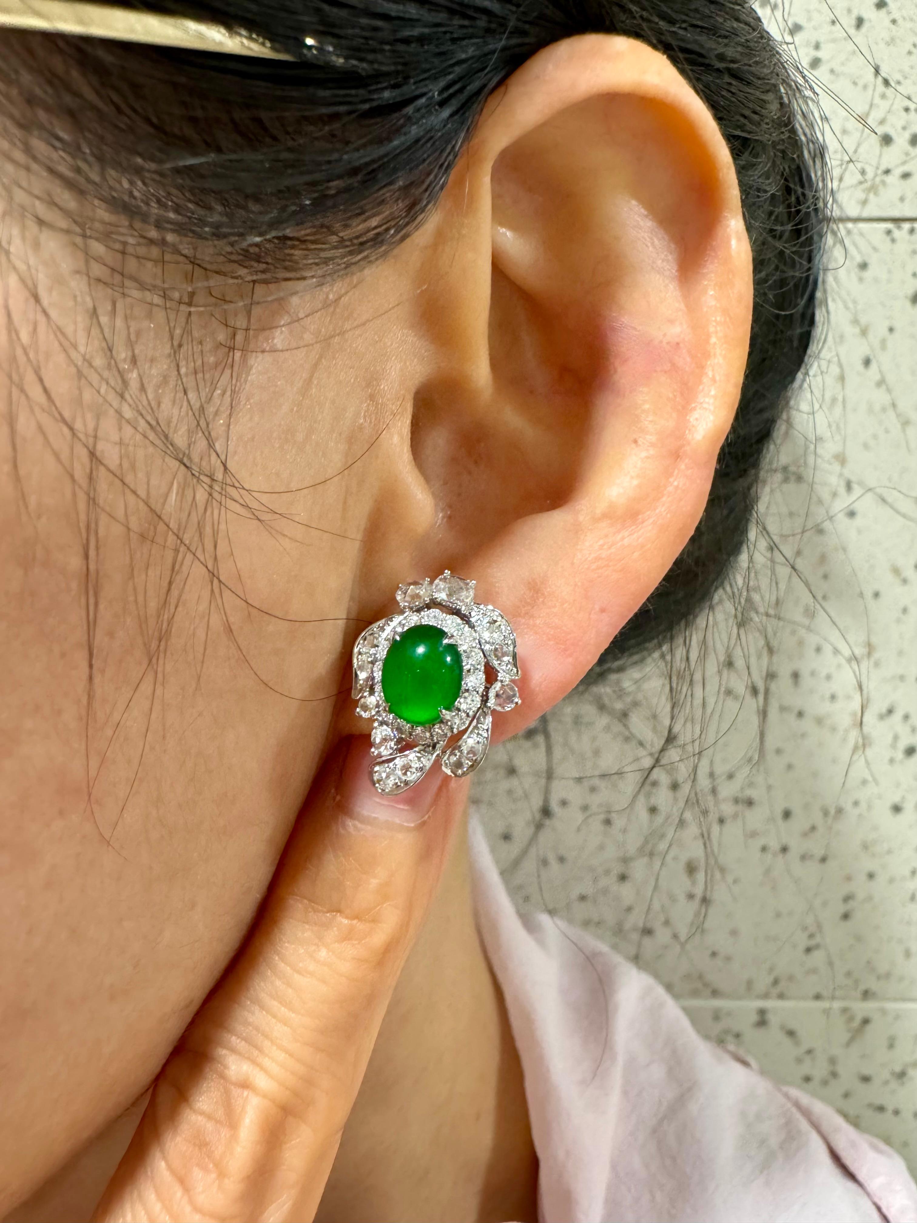 Please check out the HD video! It doesn't get much better than this! Here is a nice pair of true imperial green Jadeite Jade earrings. It has the best of the best glowing green color. The earrings are about 19.7mm x 15.3mm each in outer diameter.