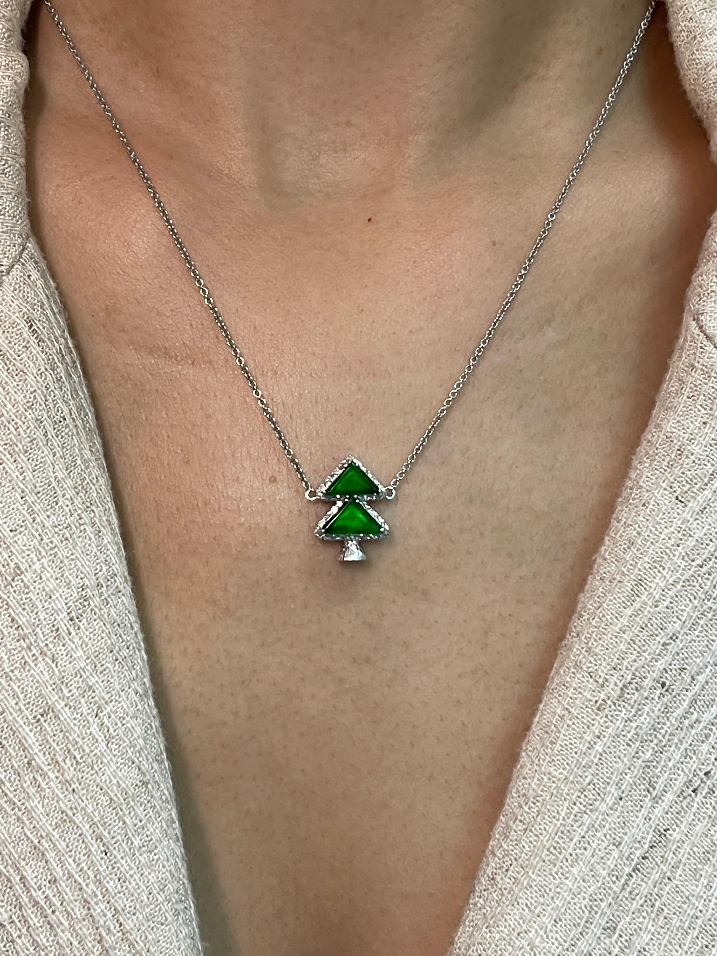 Natural jade that glows are rare and in high demand. This is certified by 2 labs to be natural jadeite jade. The pendant is set in 18k white gold and diamonds. There are a total of 0.15 cts of diamonds in this setting. Two apple green triangle jade