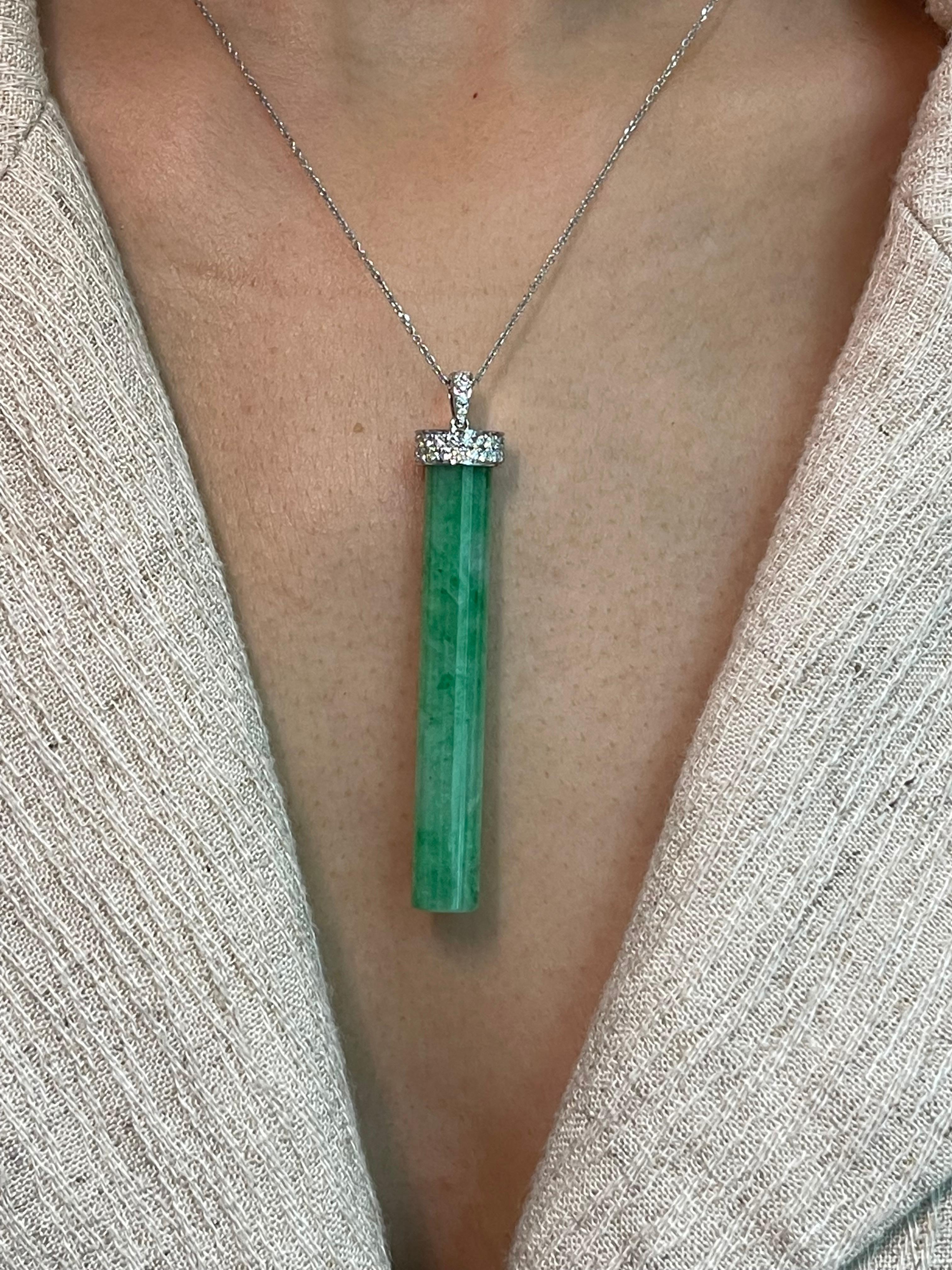 Please check out the HD video! This is certified to be natural jadeite jade. The pendant is set in 18k white gold and diamonds. There are a total of 0.42 cts of diamonds in this setting. In jadeite jade 2 main features determines the price 1) the