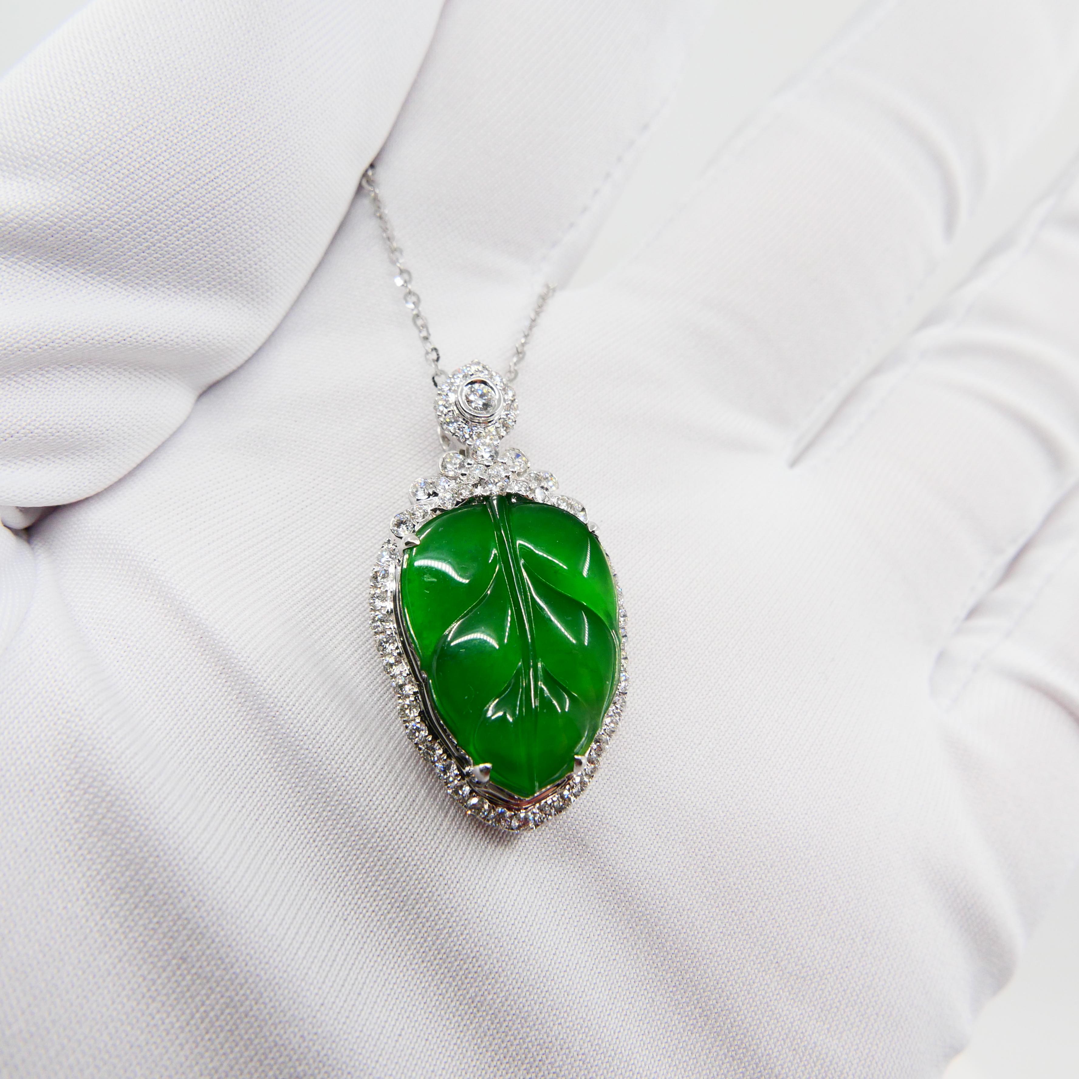 This is certified by two labs to be natural jadeite jade. The pendant is set in 18k white gold. There is one carved imperial green jade leaf motifs and 0.664cts of white diamonds in this setting. Imperial green color jades are very rare and highly