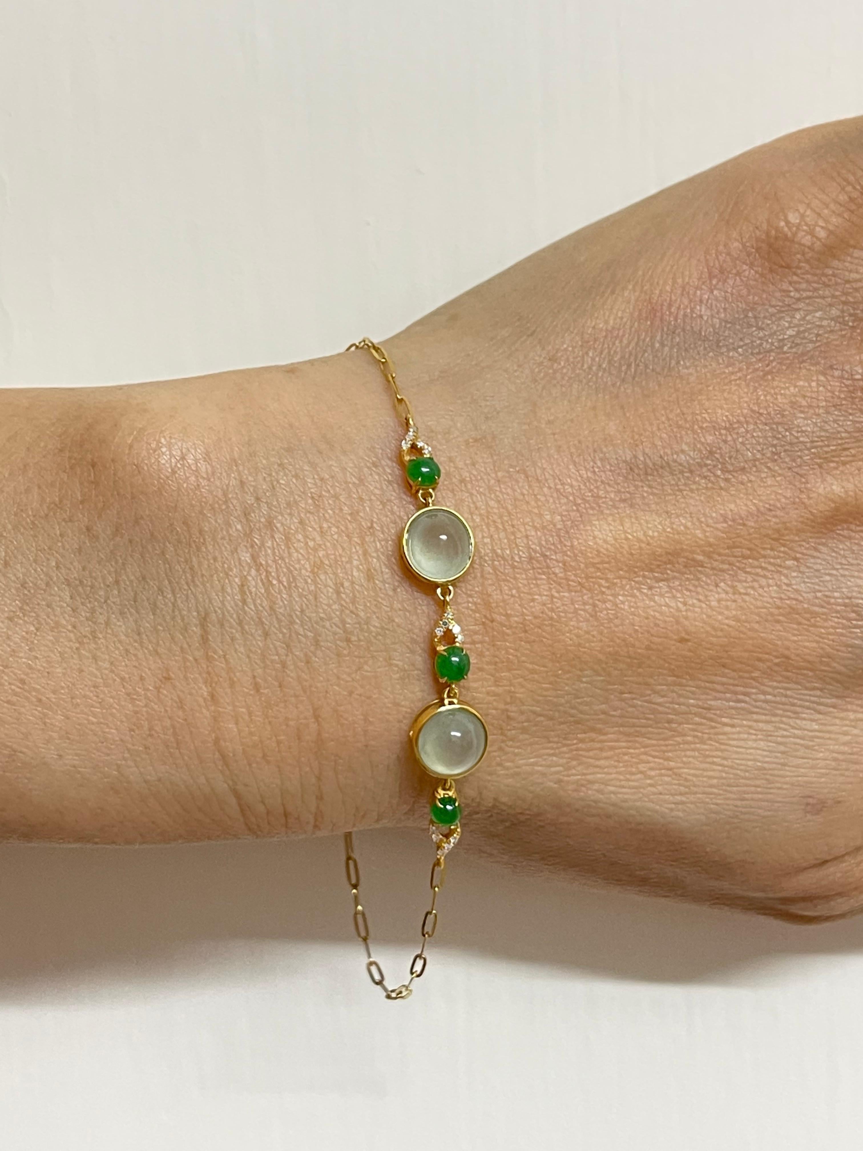 Please check out the HD video. This is certified by two labs to be natural jadeite jade. The bracelet is set in yellow gold.  2 larger icy jade cabochons and 3 smaller imperial jades make up this bracelet. There are approximately 0.02cts of white