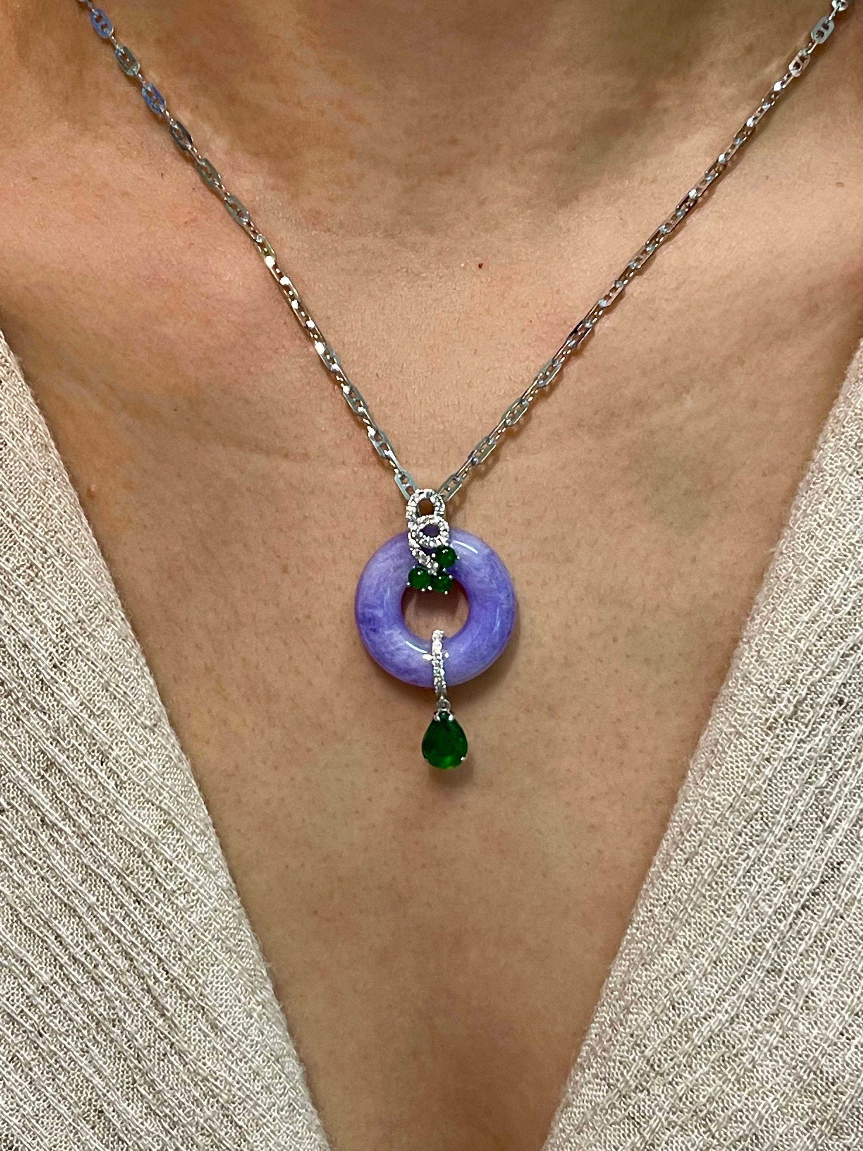 Please check out the HD video! This certified natural lavender jadeite is not common in this size and concentration of color. It is as beautiful from the front as it is from the back. The lavender jade donut (peace buckle) pendant is simple and