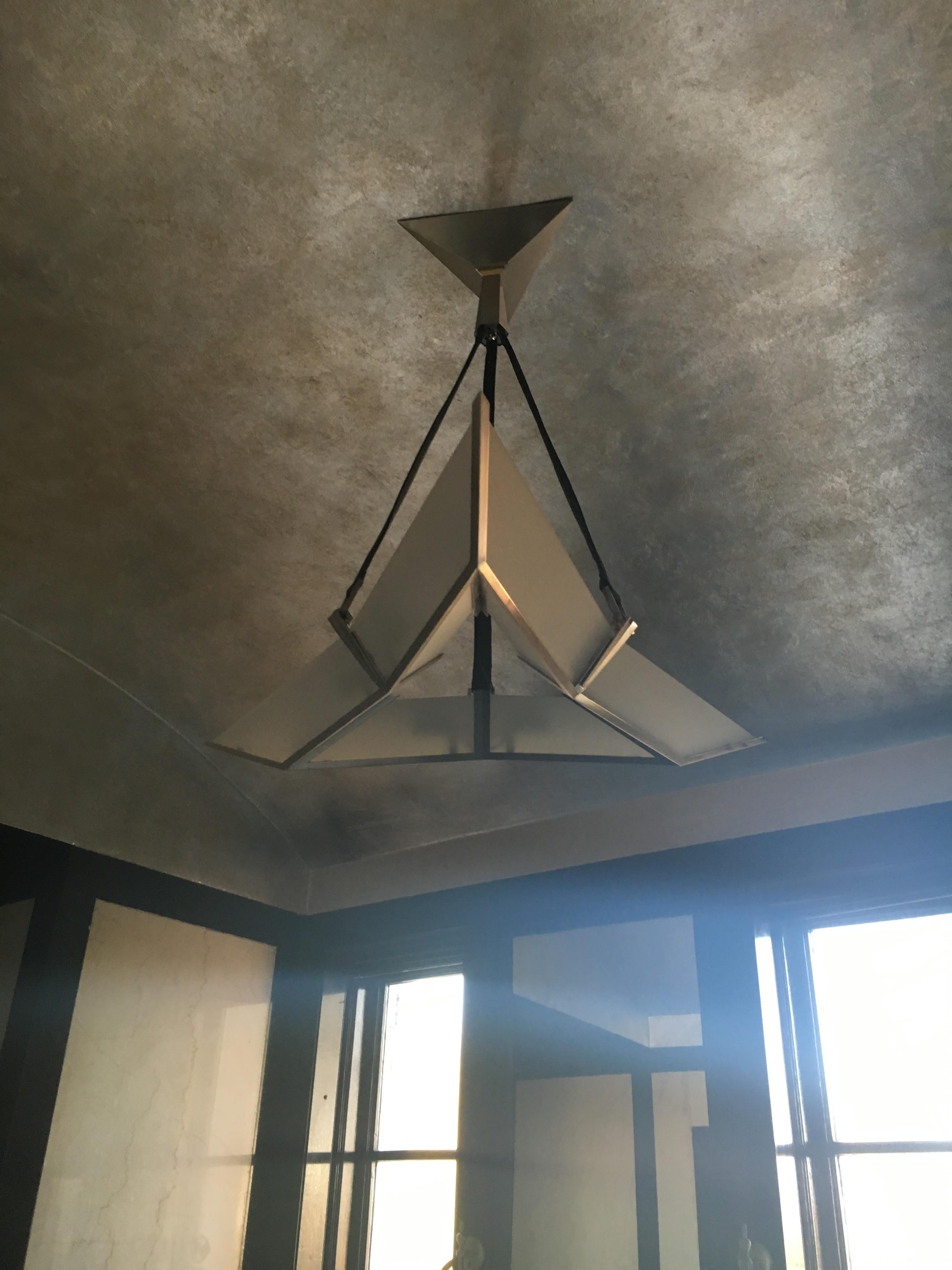 #20035 Etoile Maison Baguès chandelier. Finish: Polished nickel (other finishes available)
Leather and polished nickel over bronze

UL listing available for an additional fee (install photo shown with shorter projection).
  