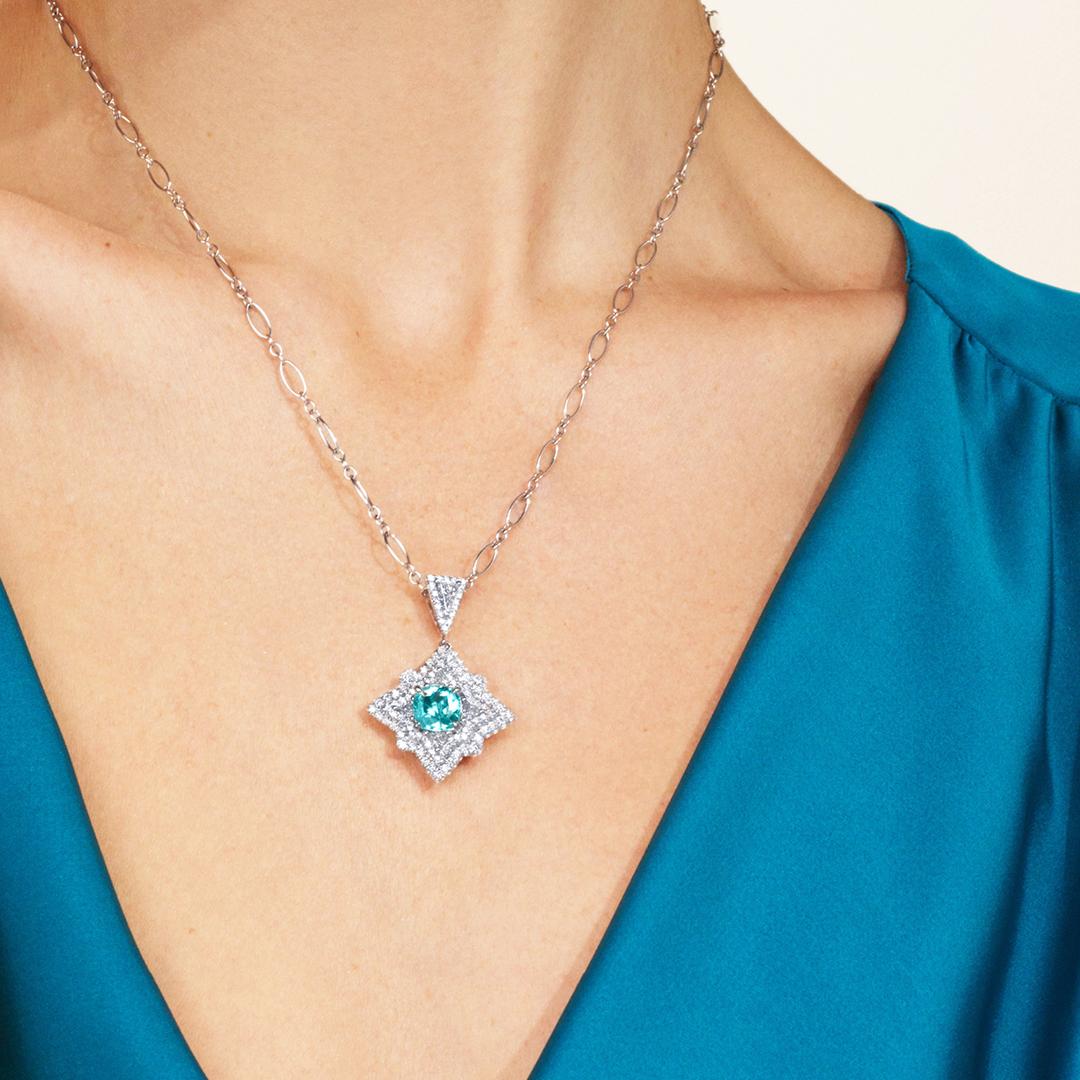 A spectacle of vivacious colors, the Paraiba is celebrated for the plethora of neon-like hues it exhibits once it has been fashioned into a faceted piece fit for jewelry. Our Starburst Pendant is an ornate design showcasing a gorgeous modified