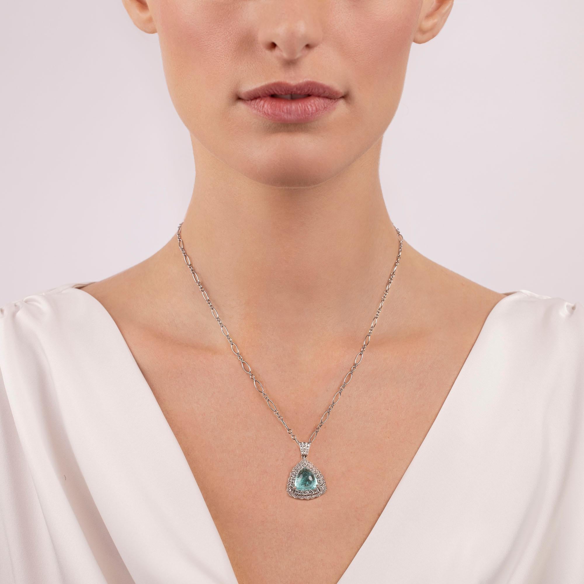 An illuminating trillion shape Paraiba cabochon rests at the center of our Prism Necklace. Traced by two rows of glittering diamonds, the pendant is suspended from a tasteful 18