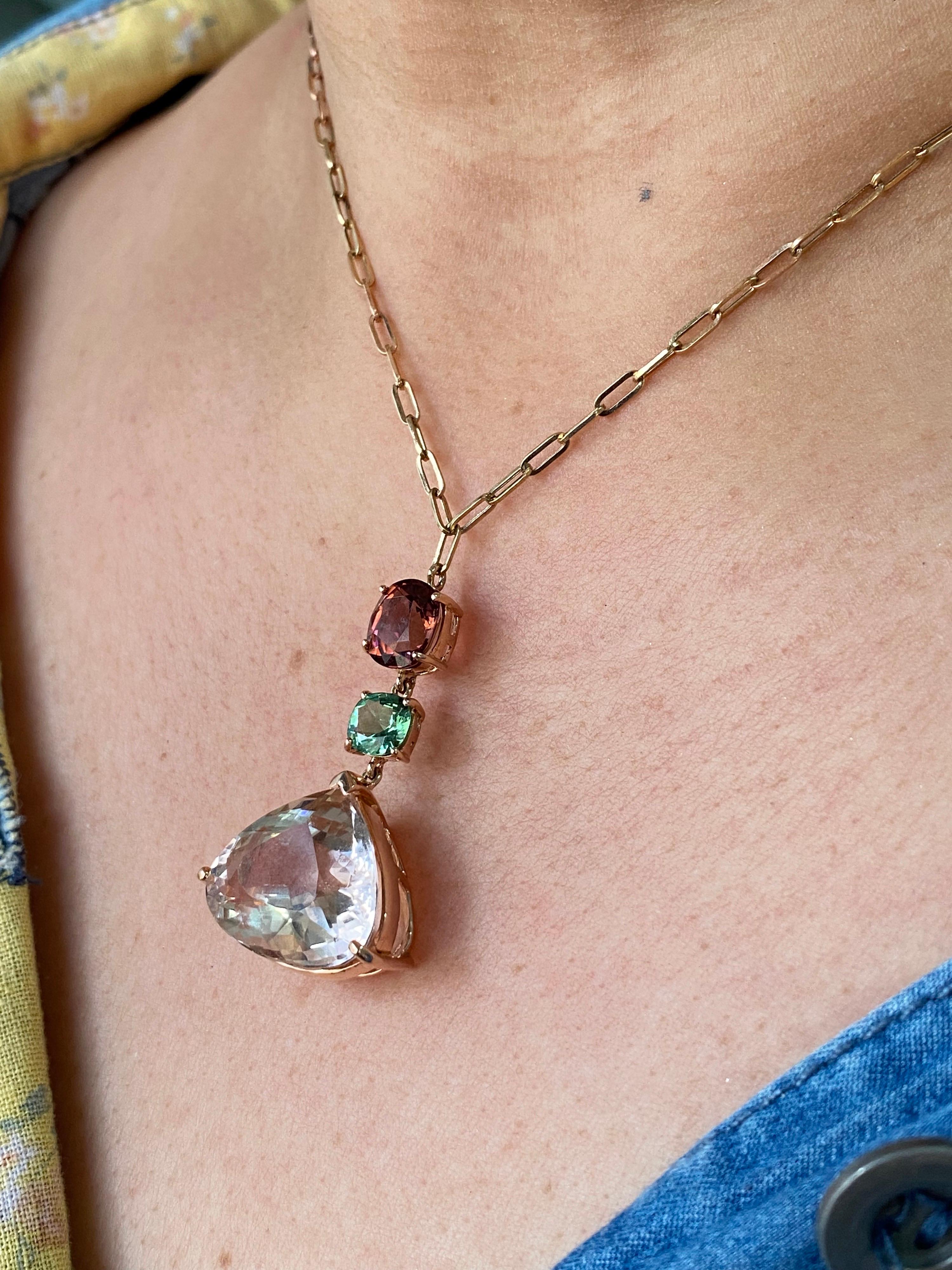 A beautiful pendant with a combination of 18.28 carat Morganite, Green Tourmaline and Rubellite, all set in solid 18K Gold. The link chain is also made of 18K Gold, and is 16 inches long. There is a pair of matching earrings available as well. The