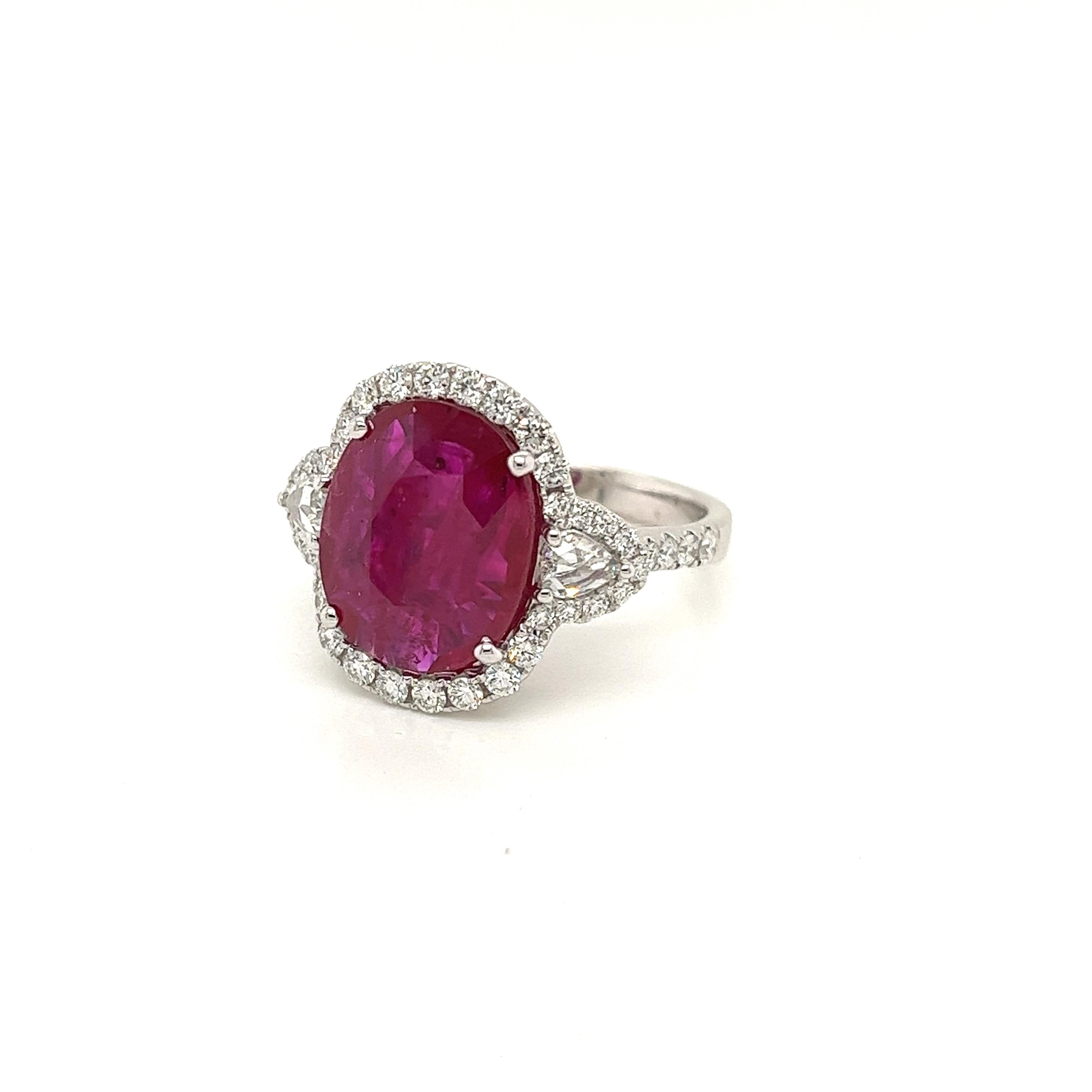 Certified Oval Mozambique Ruby weighing 4.64 carats
Measuring (13.18x10.90x3.01) mm
Diamonds weighing .93 carats
GH-SI1
Set in 18k white gold ring
6.11 g