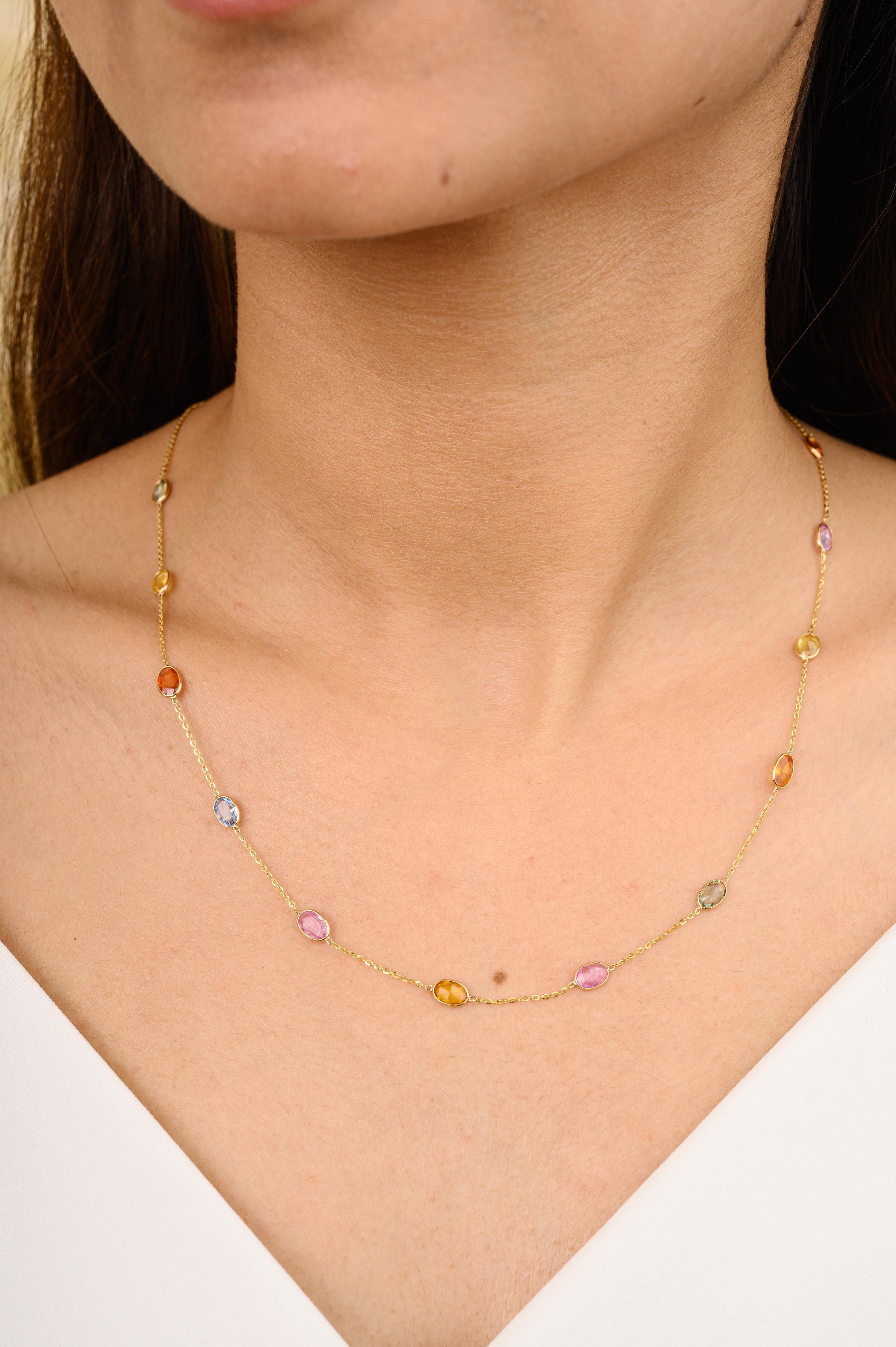 Certified Multi Sapphire Station Chain Necklace for Women in 18K Gold studded with oval cut multi sapphire. This stunning piece of jewelry instantly elevates a casual look or dressy outfit. 
Sapphire stimulate concentration and reduces