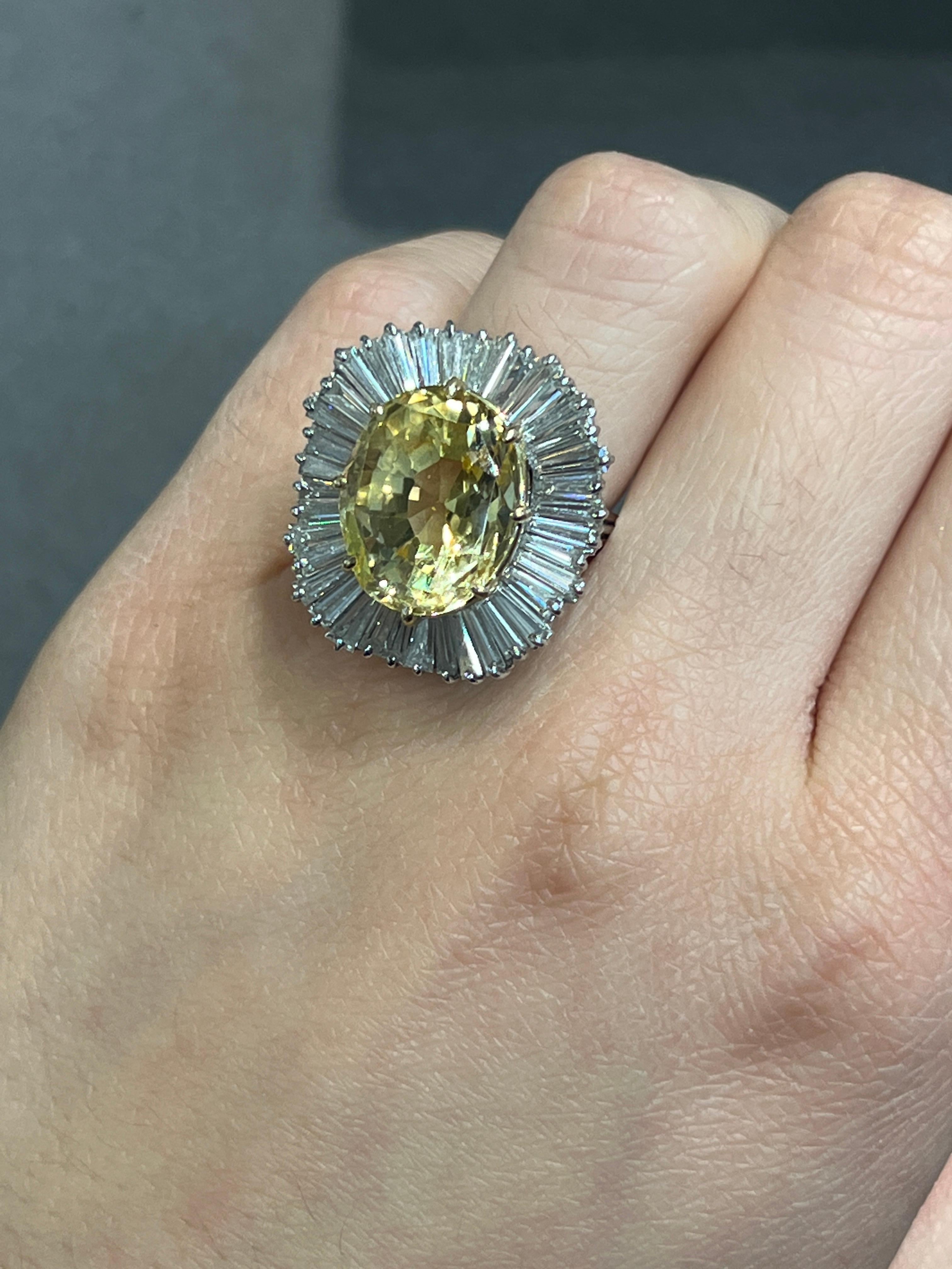 Certified Natural 14.69 Carat Yellow Sapphire Ballerina Ring 

A platinum ballerina ring set with an oval yellow sapphire accented by 38  tapered baguette-cut diamonds

Accompanied by AGL, stating the sapphire is unheated and of Ceylon