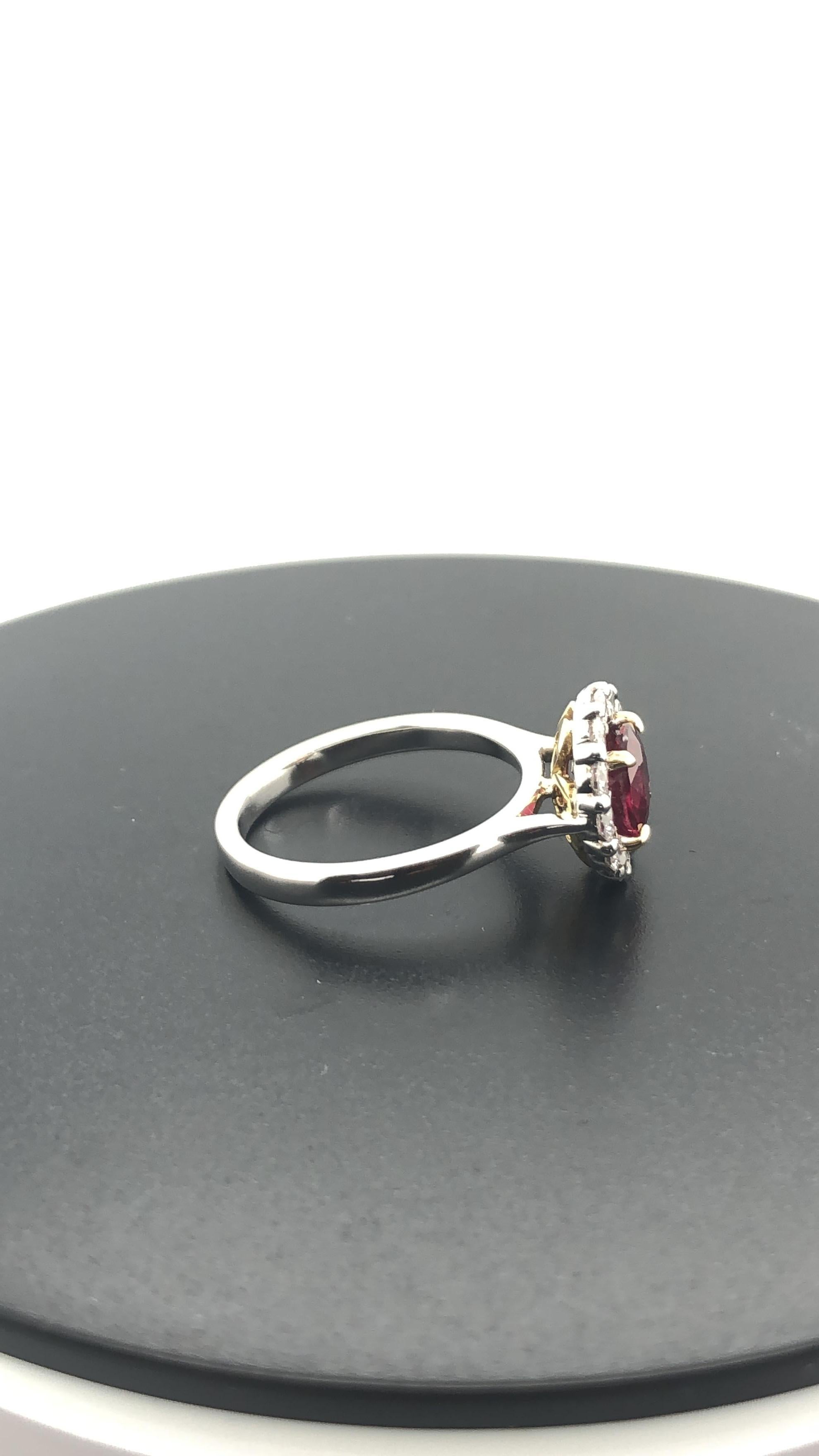 Hand Crafted 18 Carat Yellow and White gold Ring, Set with a Certified, Natural 'Deep Red' Mozambique 1.58 carat Round Ruby as per GSL # AA61057, set in Yellow gold claws, surrounded by 12 round brilliant cut white diamonds, weighing 0.60 carat, F