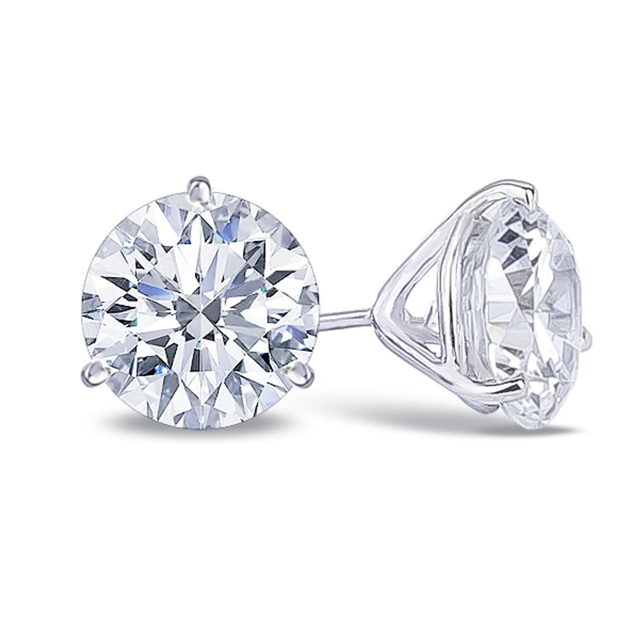 These exquisite diamond stud earrings showcase a pair of perfectly matched round brilliant cut diamonds, each weighing 1.01 carats for a total of 2.02 carats. 
Expertly set in lustrous 14K white gold, they offer a timeless silhouette with