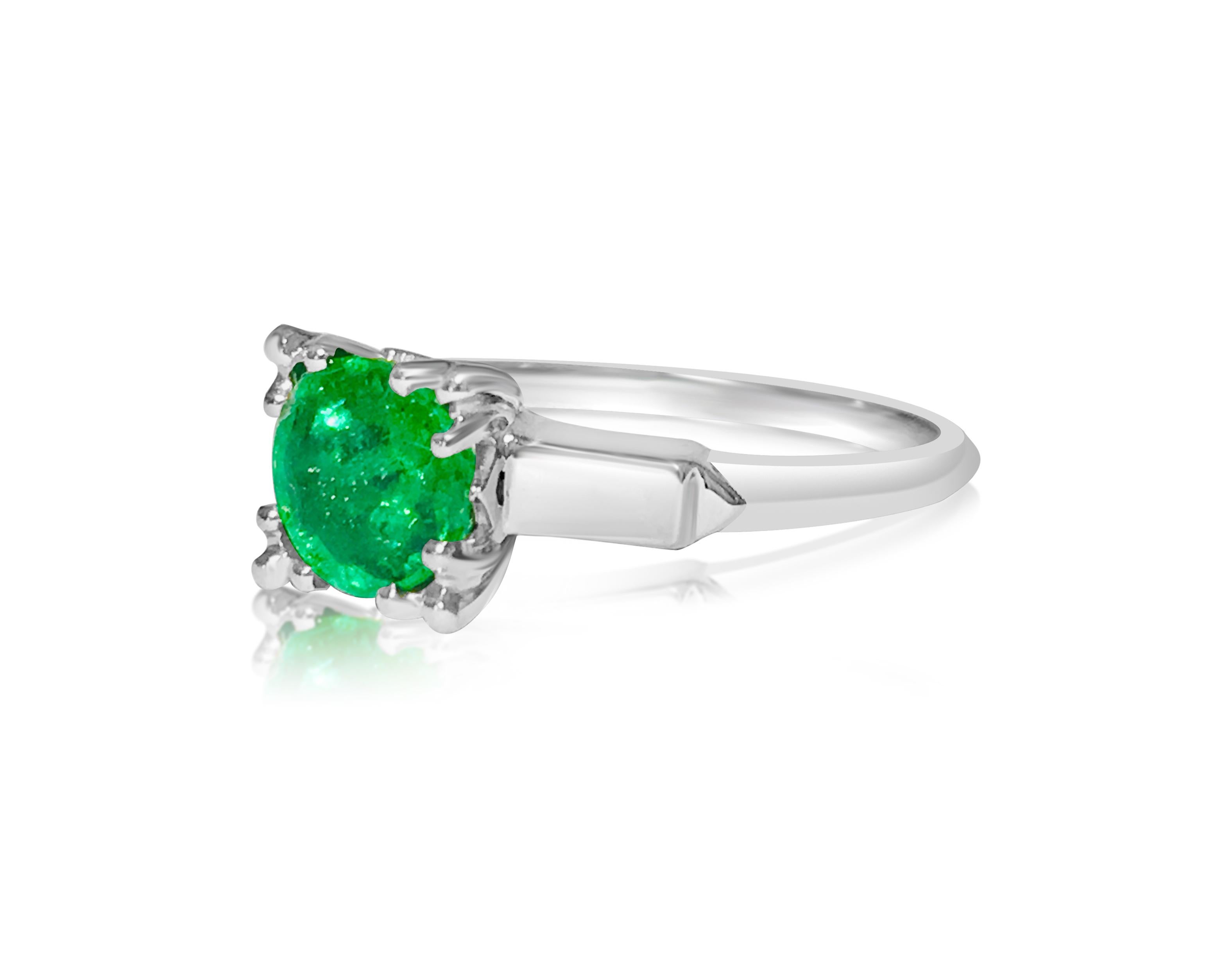 This exquisite vintage ring features a captivating 2.00-carat emerald, showcasing a stunning intense green hue that mesmerizes the beholder. Crafted from platinum, this ring exudes elegance and sophistication, with its unique design setting it apart