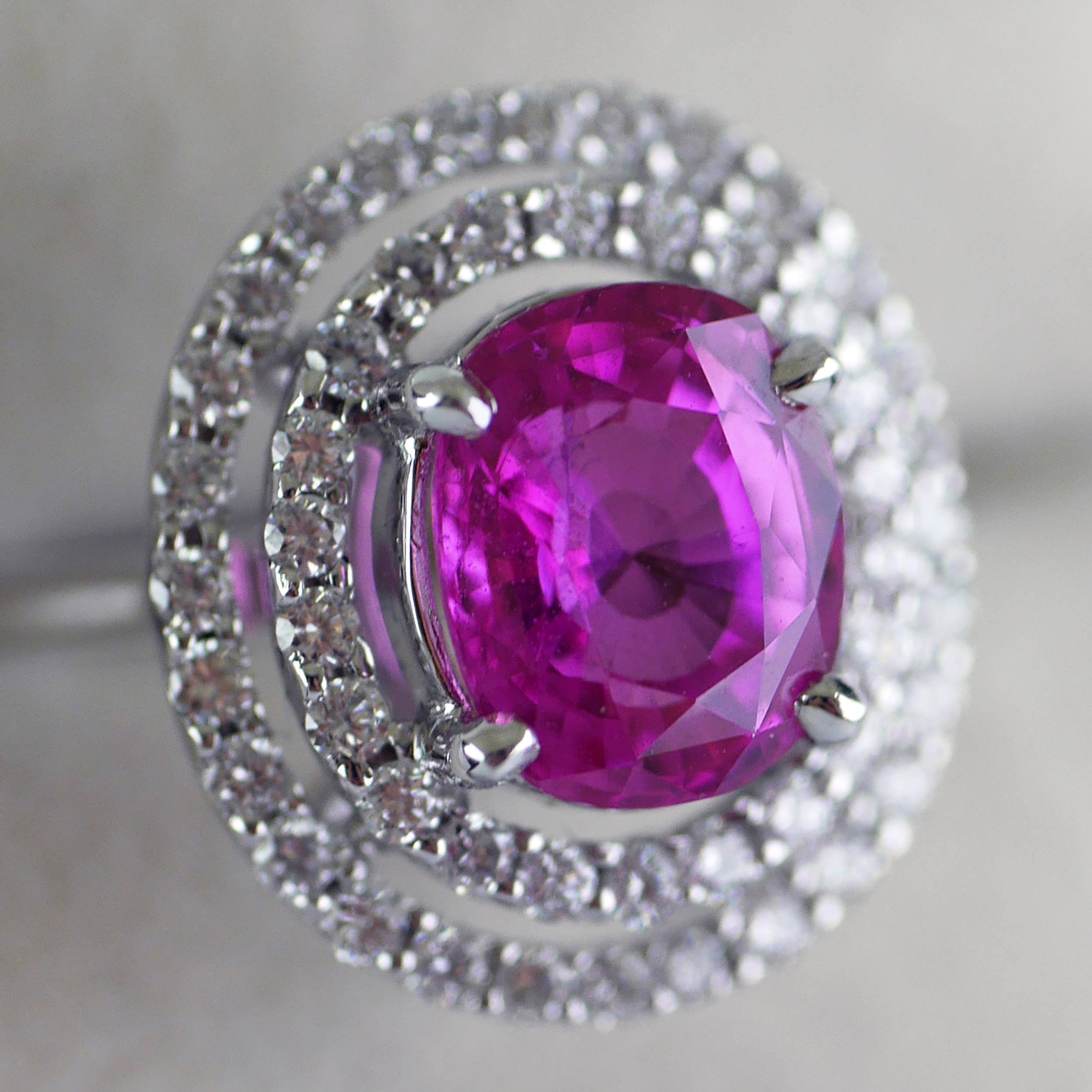 Vintage ring with a natural, untreated, pink sapphire, handmade in England, circa 1970.

Central Madagasgar pink sapphire, cushion cut, weighing 2.91ct, certified, natural untreated colour. 

The sapphire surrounded by round brilliant cut diamonds,