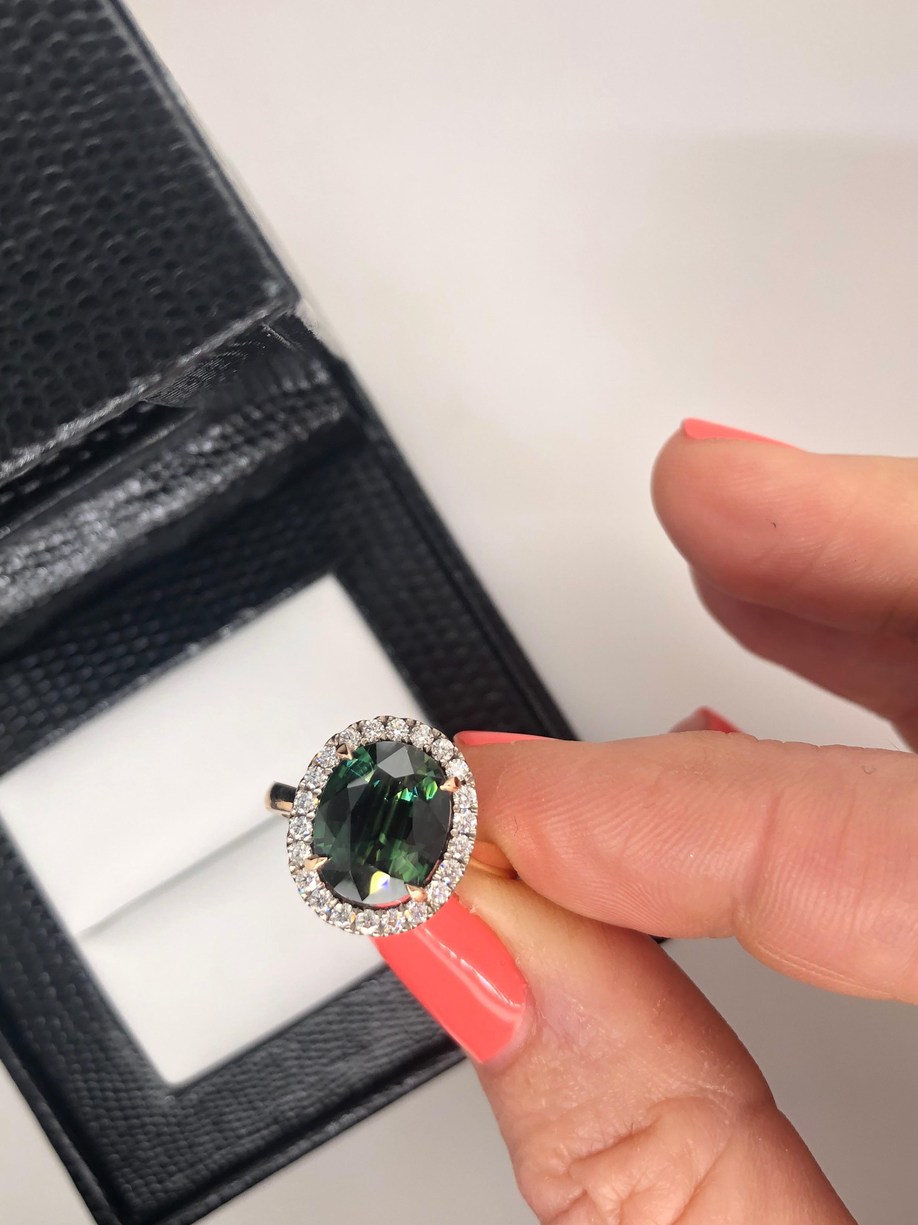 Hand Crafted, 18ct rose and white gold Natural 'Deep Green' 3.73ct Sapphire as per GSL Certificate AA62767/4, set in rose gold claws, surrounded by white gold, claw set white diamonds, weighing 22 = 0.30ct F in colour, VS in clarity. Suspended on a