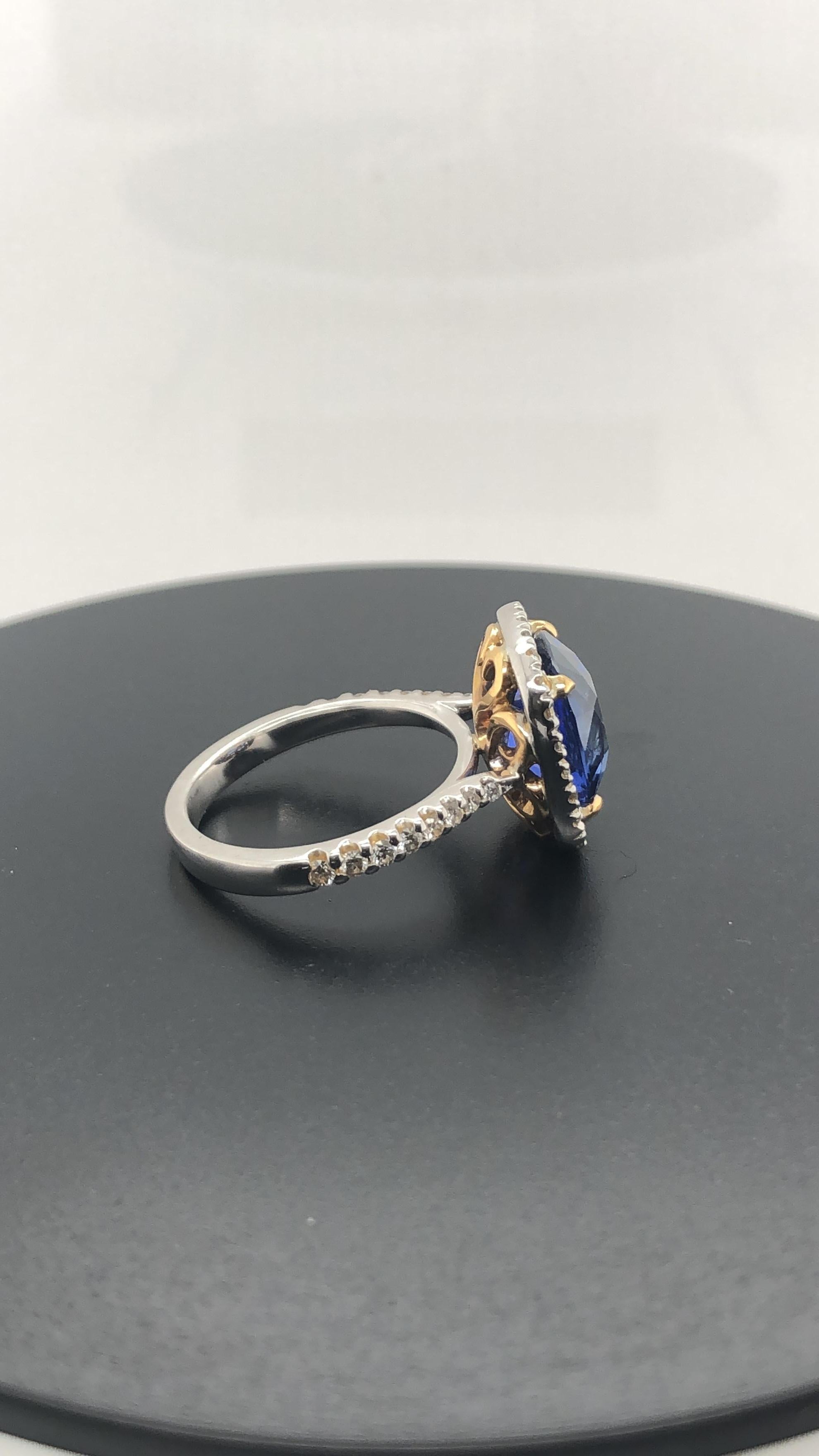 Hand Crafted 18 Carat Rose and White Gold Ring, set with one Certified, Natural, 6.09 Carat, Cushion cut 'Deep Blue' Ceylonese Sapphire as per GSL AA 55221, in rose gold Talon Claws and surrounded by a halo of 24 claw set Round Brilliant cut
