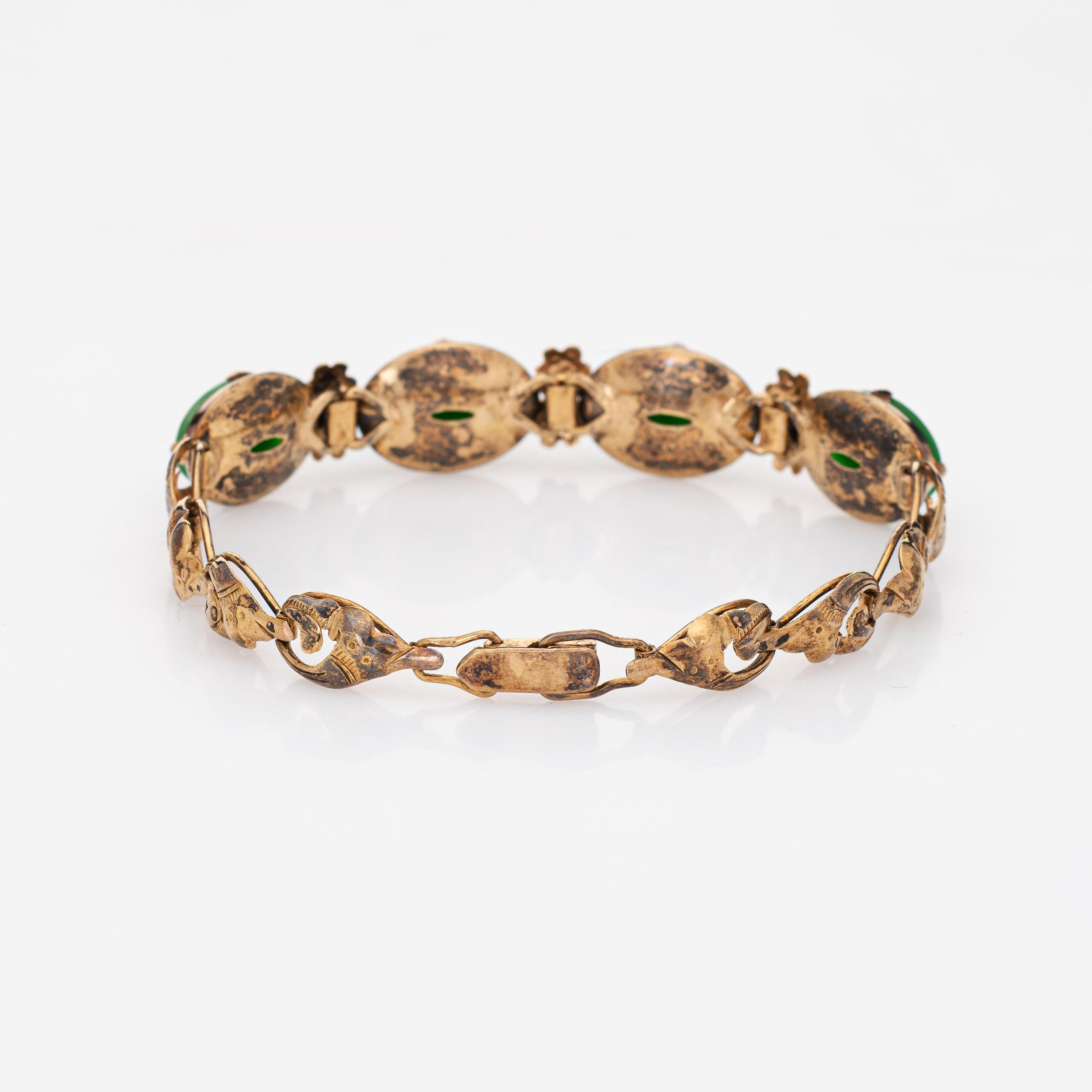 Stylish natural 'A' grade jadeite jade bracelet (circa 1940s to 1950s), crafted in 14k yellow gold. 

Four pieces of cabochon cut jadeite jade measure 12.20 x 8.90 x 1.90mm. The jade is in excellent condition and free of cracks or chips. The jade is