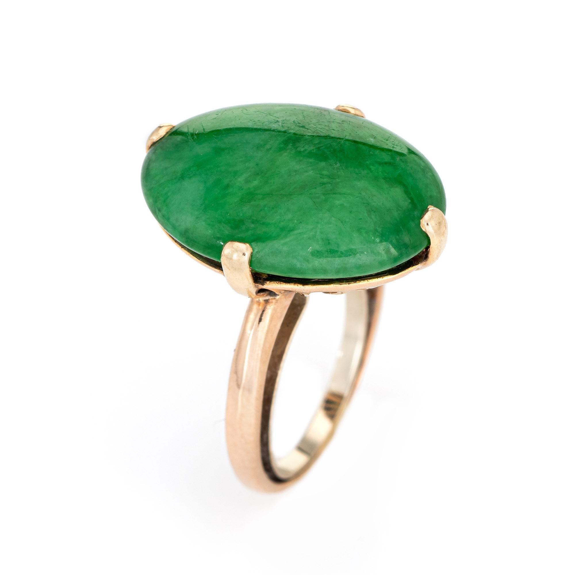 Stylish vintage natural 'A' grade jadeite jade cocktail ring (circa 1960s to 1970s) crafted in 14 karat yellow gold. 

Cabochon cut jadeite jade measures 15.55 x 20.60mm. The jade is in excellent condition and free of cracks or chips. 

The
