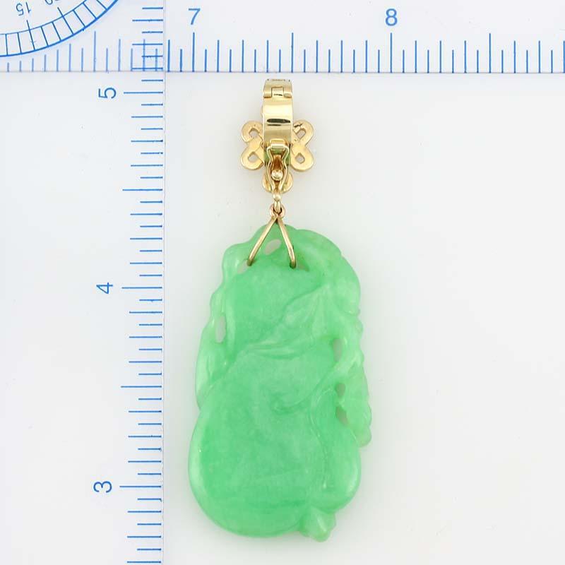 A Classic Mason-Kay Pendant Style. Beautiful, natural carved apple green jadeite jade pendant on a 14K yellow gold endless knot design detachable bail. The carving is a gourd with vines. Use the detachable to place on your favorite strand of jade,