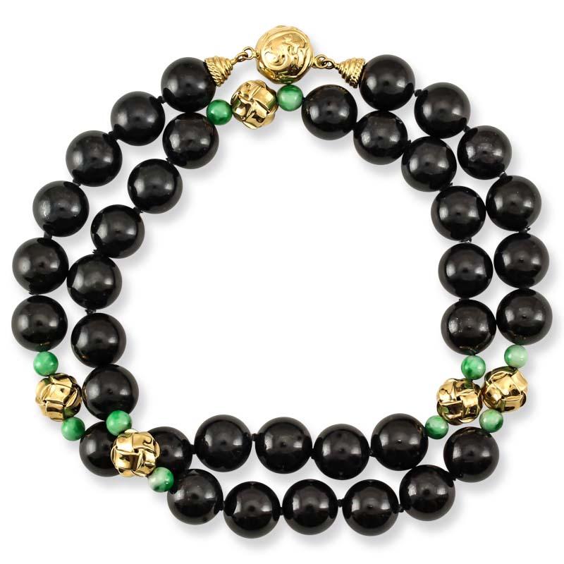 This one-of-a-kind Mason-Kay Jade Designer necklace features 11mm natural black jade beads with natural green jade bead accents with fancy 14K yellow gold 'woven knot' designed beads and matching clasp. This necklaces is 21 inches long.   

***