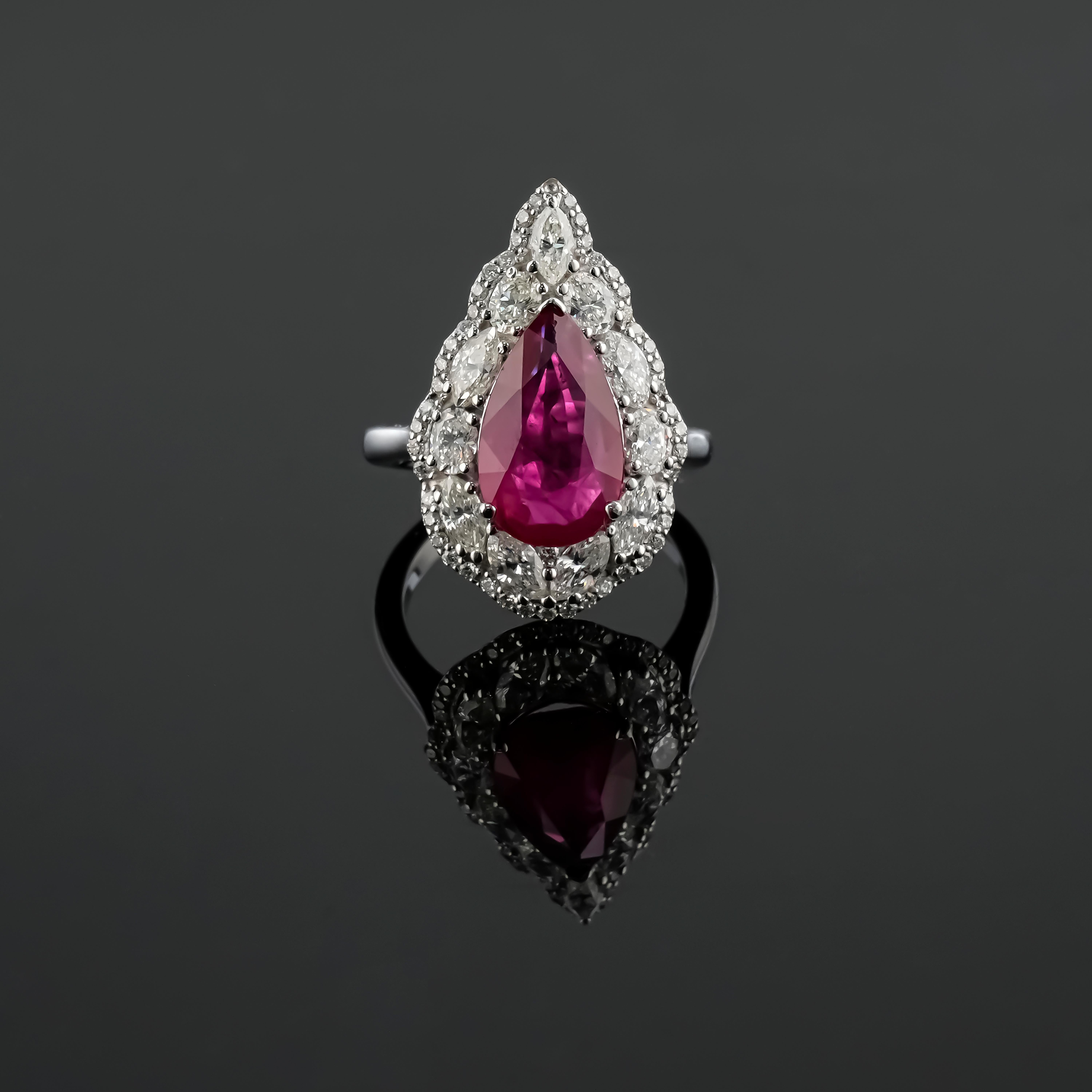 A vivid pear-shaped Burmese ruby weighing 3.91 carats, renowned for its deep, rich color and exceptional clarity . 

Encircled by 60 meticulously selected diamonds, including:
7 marquise-cut diamonds totaling 1.02 carats.
4 oval-cut diamonds