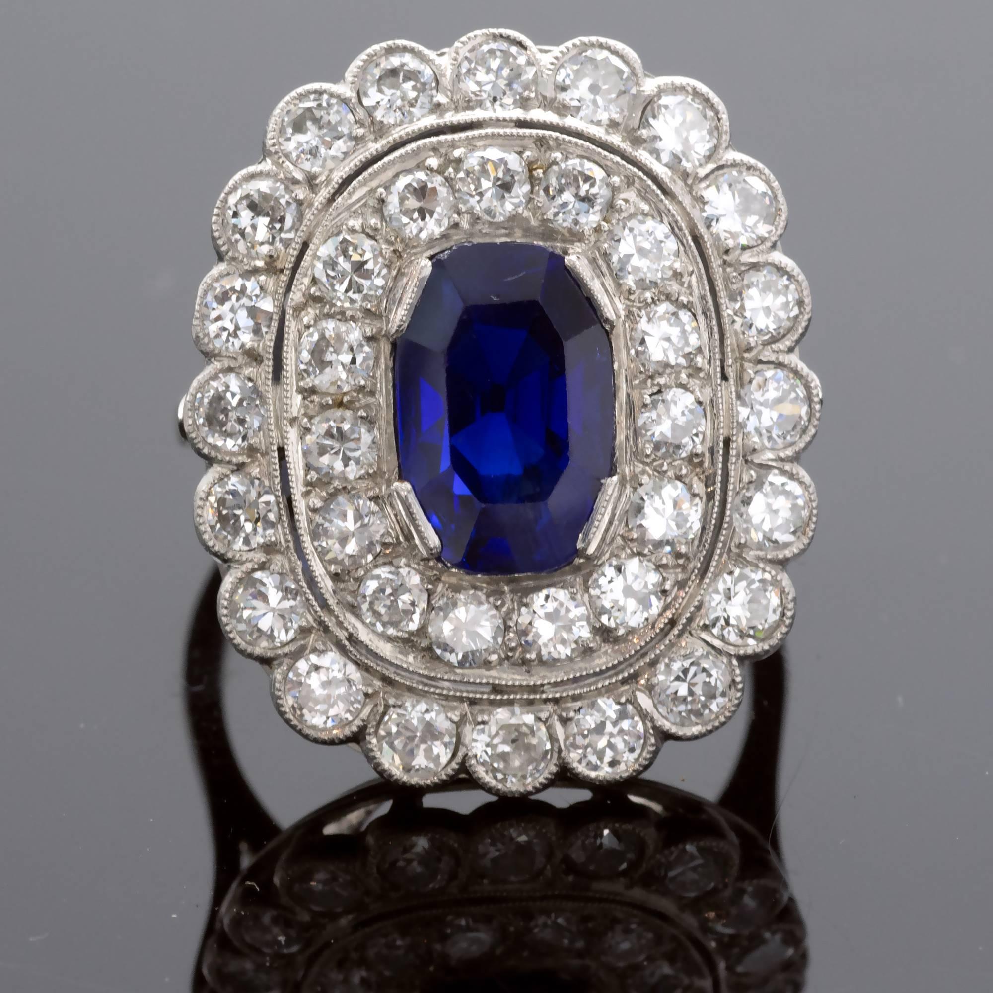 Exquisite Art Deco halo ring set in its center with a natural sapphire from Burma with a rich colour surrounded with two rows of diamonds. The ring comes with an renown AGL certificate  stating that the sapphire present no indication of heating or