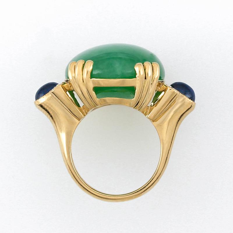 Amazing Designer Ring! Large natural green jadeite jade oval cabochon ring fit for the Queen! The beautiful green jadeite oval cabochon is set in a heavy 18K yellow gold mounting with four round diamonds and two gorgeous oval cabochon sapphire side