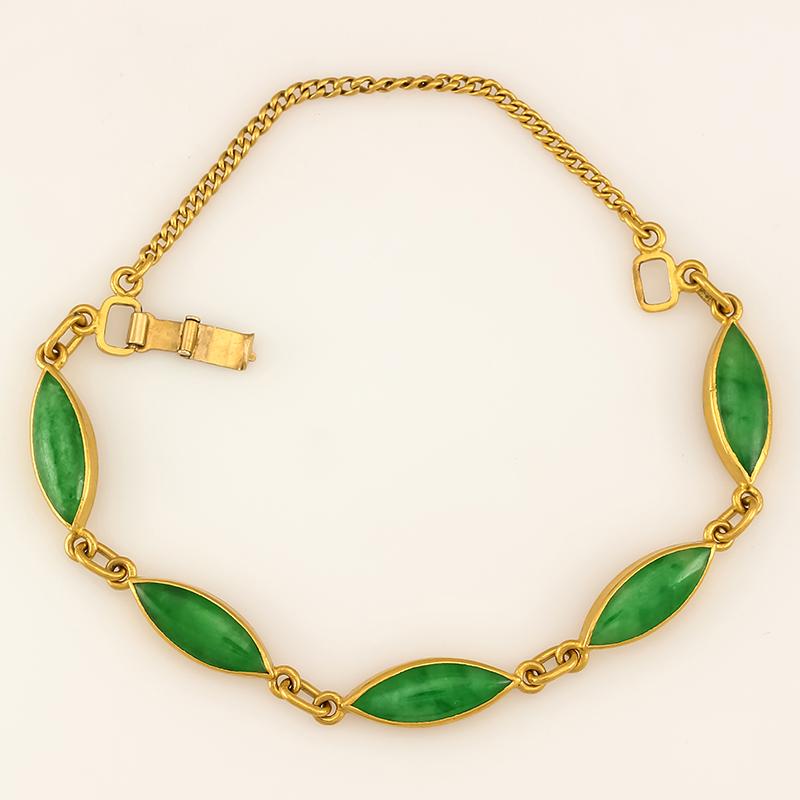 Just an exquisite classic bracelet! Five natural vivid green jadeite jade marquise cabochons (approx. 6 x 18mm each) set in rich 22K yellow gold bezels, backing and clasp with safety chain. 
Perfect for a 6.5