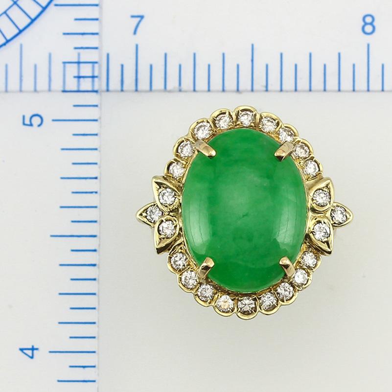 What a beautiful, one-of-a-kind Mason-Kay Design. Featuring a 13x17mm Certified Green Jadeite Jade Oval Cabochon set in a fancy 14K yellow gold mounting with scalloped frame and .65cts of round diamonds total! Magnificent! Finger size 6.5.

***