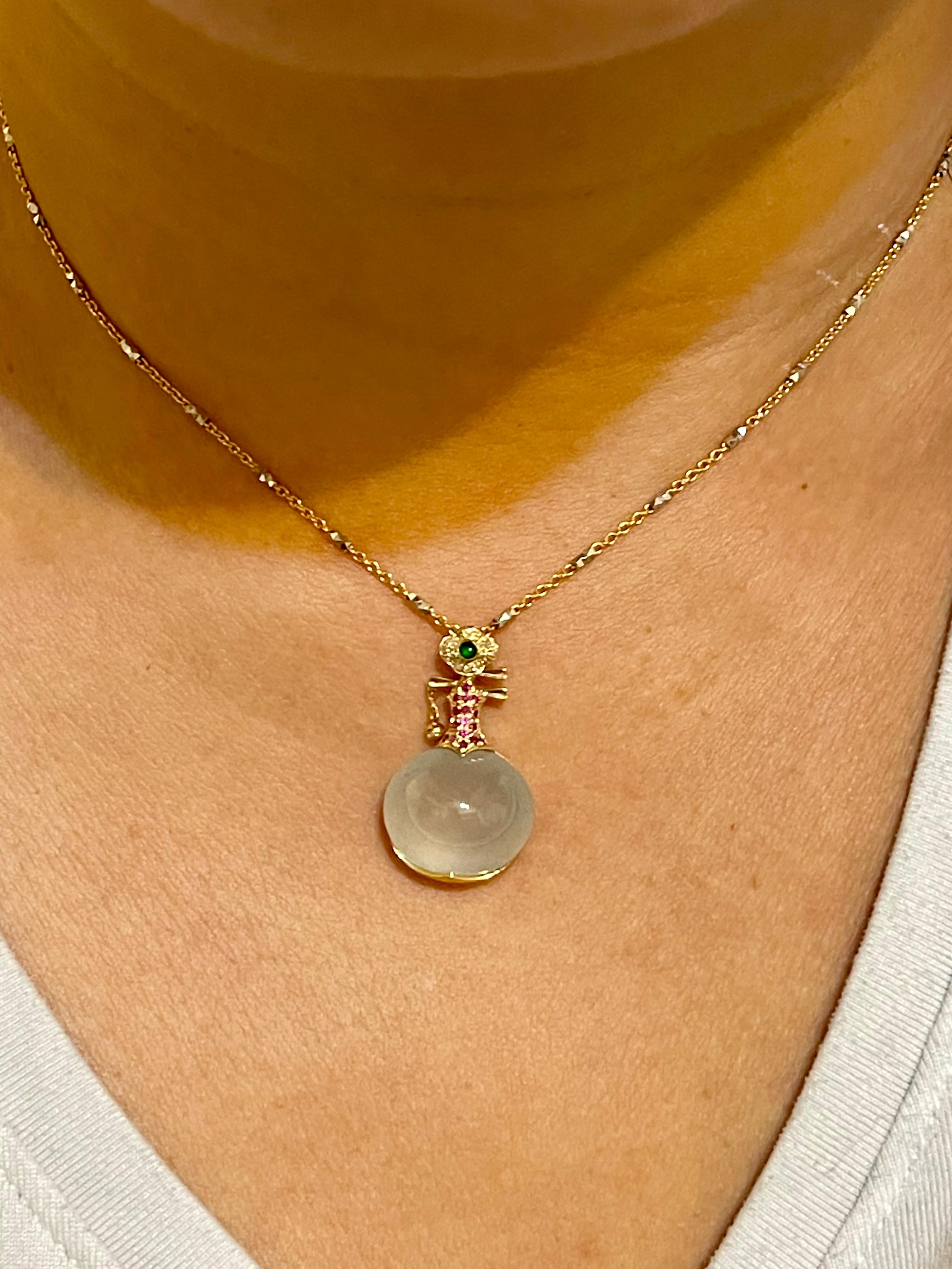 THIS JADE GLOWS! Here is a rare ICY Jade and diamond pendant. This musical lute pendant is set in 18k yellow gold with a nice imperial green jade, diamonds, rubies and an impressive icy jade. In the Chinese culture, the lute symbolizes fidelity and