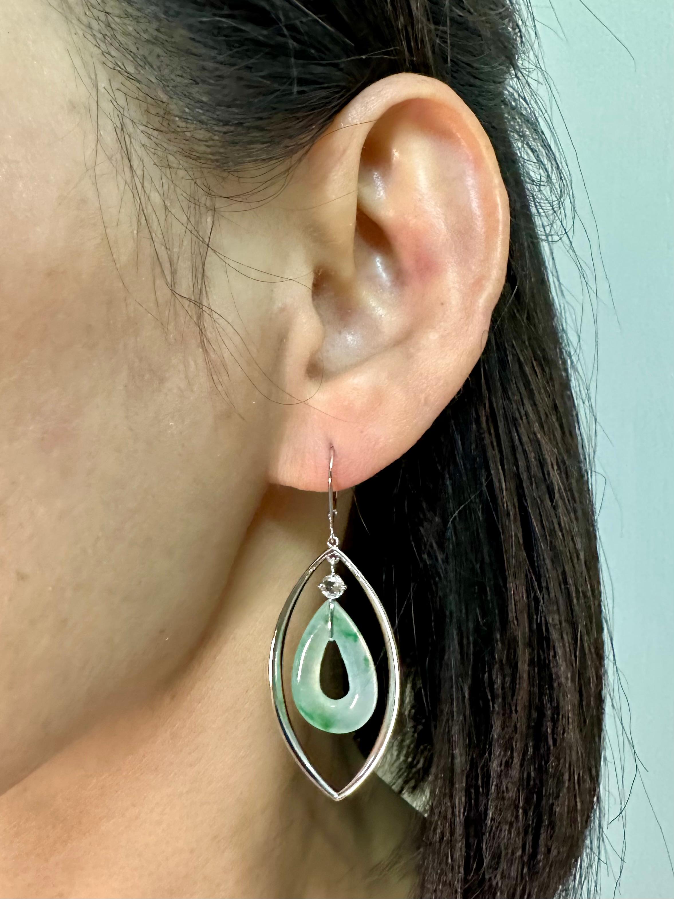 Please check out the HD video. Here is a speciality cut Jade (13.80 cts) earrings. The jade earrings are highly translucent with some apple green color veins running through them. The earrings are set in 18k white gold with 2 new rose cut diamonds