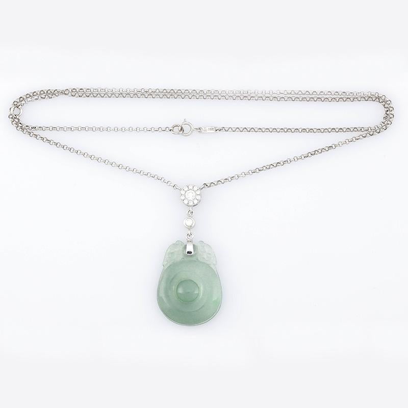 Amazing Translucency! What a glow this piece has on the skin - so beautiful. Natural icy, watery green jade circular carving with two dragons at the top, set in 18K white gold and diamond necklace. The chain is 18
