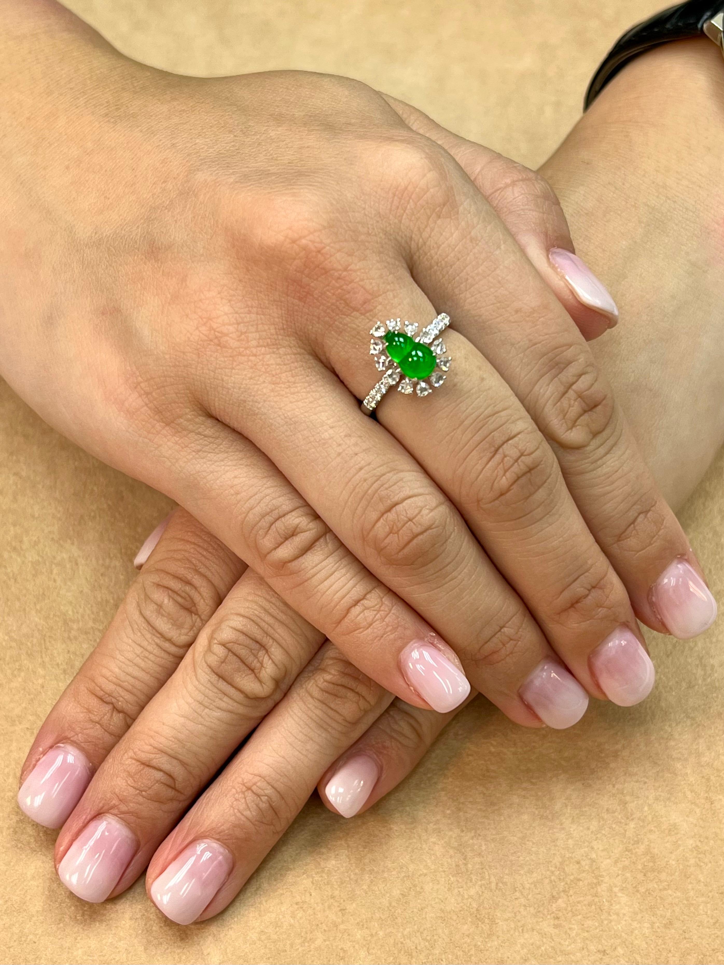 Please check out the HD video. Here is an imperial green Jade ring. This jade and diamond cocktail ring has maximum glow. It is certified by 2 labs The jade gourd represents the Fulu double, it protects people's happiness. It also means 