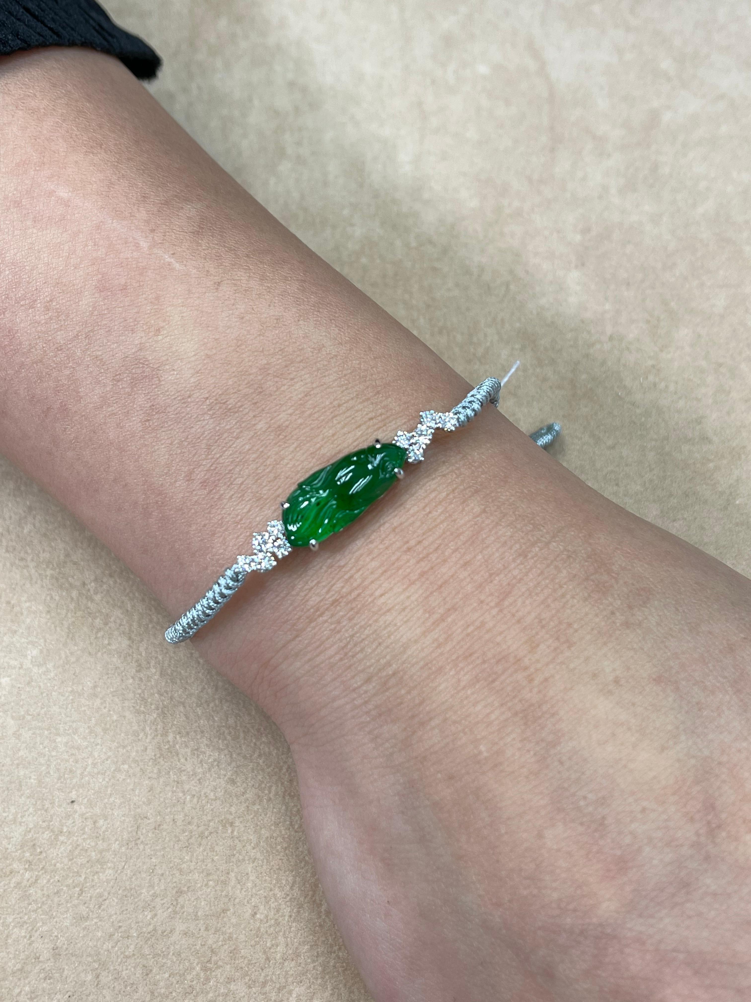 This is certified by two labs to be natural jadeite jade. The bracelet is set in white gold and diamonds. The imperial carved jade is with a fish motif and 0.512 cts of white diamonds. The imperial jade has the correct color and translucency. You