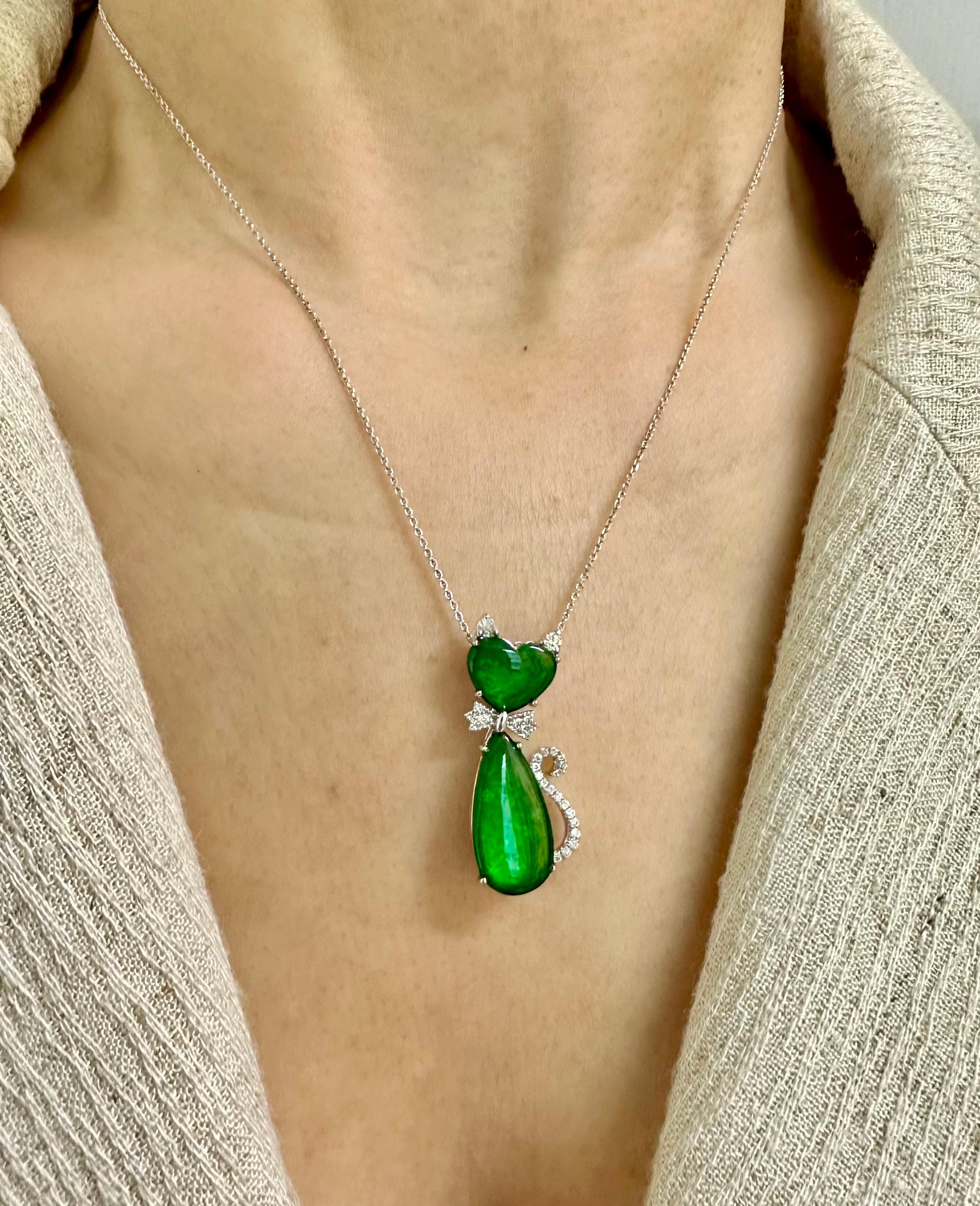 Please check out the HD video. This jade cat has a beautiful balance of color saturation and transparency! Here is a natural intense apple green Jade and diamond pendant. It is certified. The pendant is set in 18k white gold and diamonds. There are