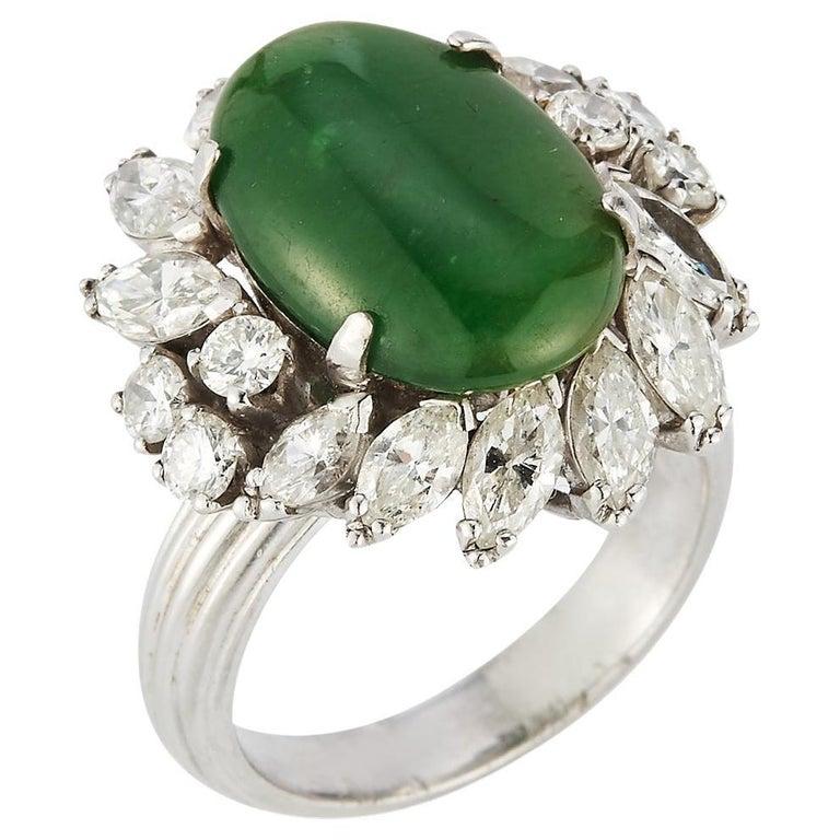 Certified Natural Jadeite Jade & Diamond Cocktail Ring
1 cabochon center jade surrounded by 12 marquise cut diamonds approximately  1.88 ct and 6 round cut diamonds approximately  .40 ct set in platinum.

Ring Size:  6

Resizable free of